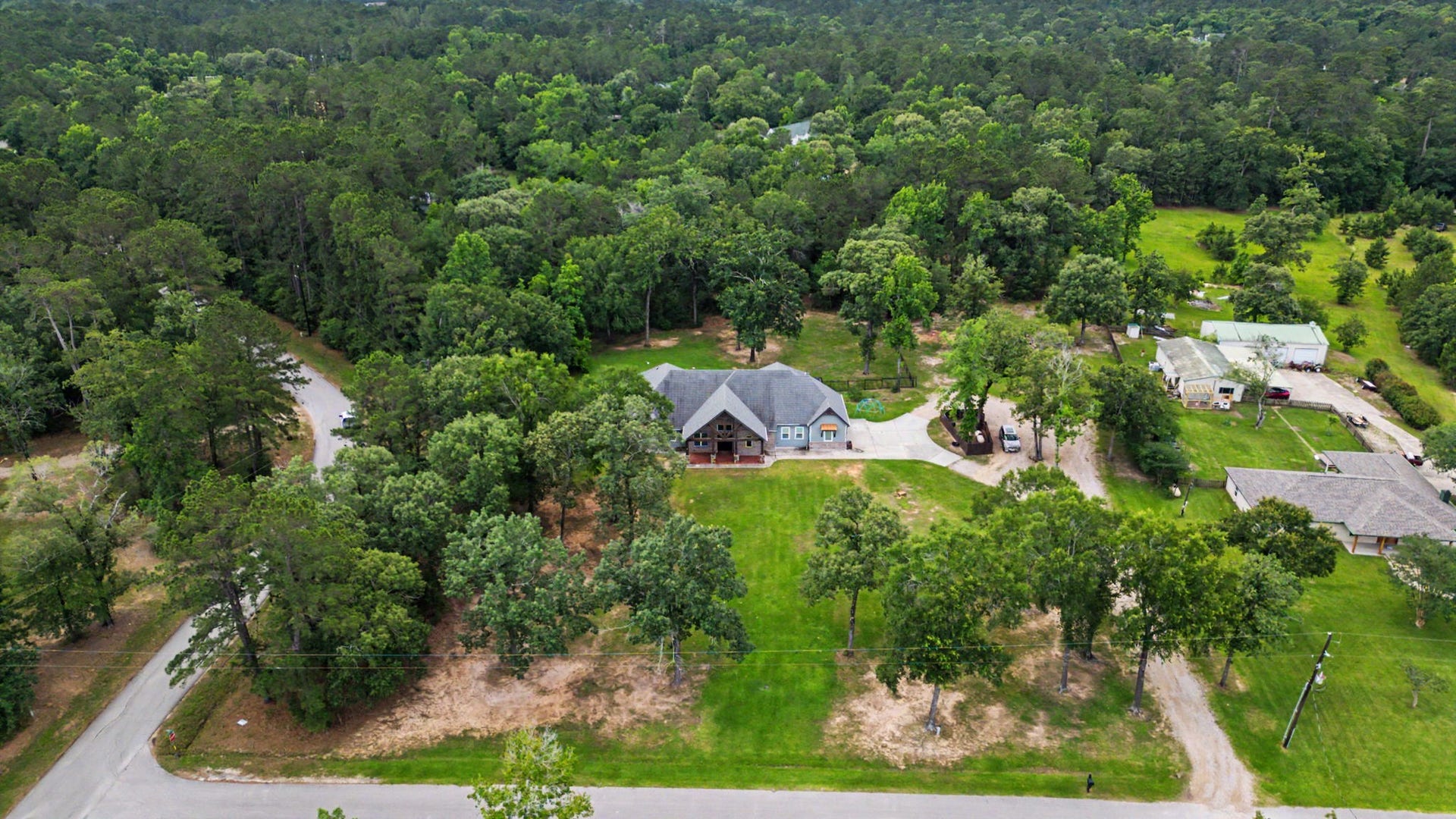 11865 Hope Lane, Magnolia, TX 77354 This aerial view captures the expansive grounds, mature trees, and serene setting that make this 5-acre property a private retreat.