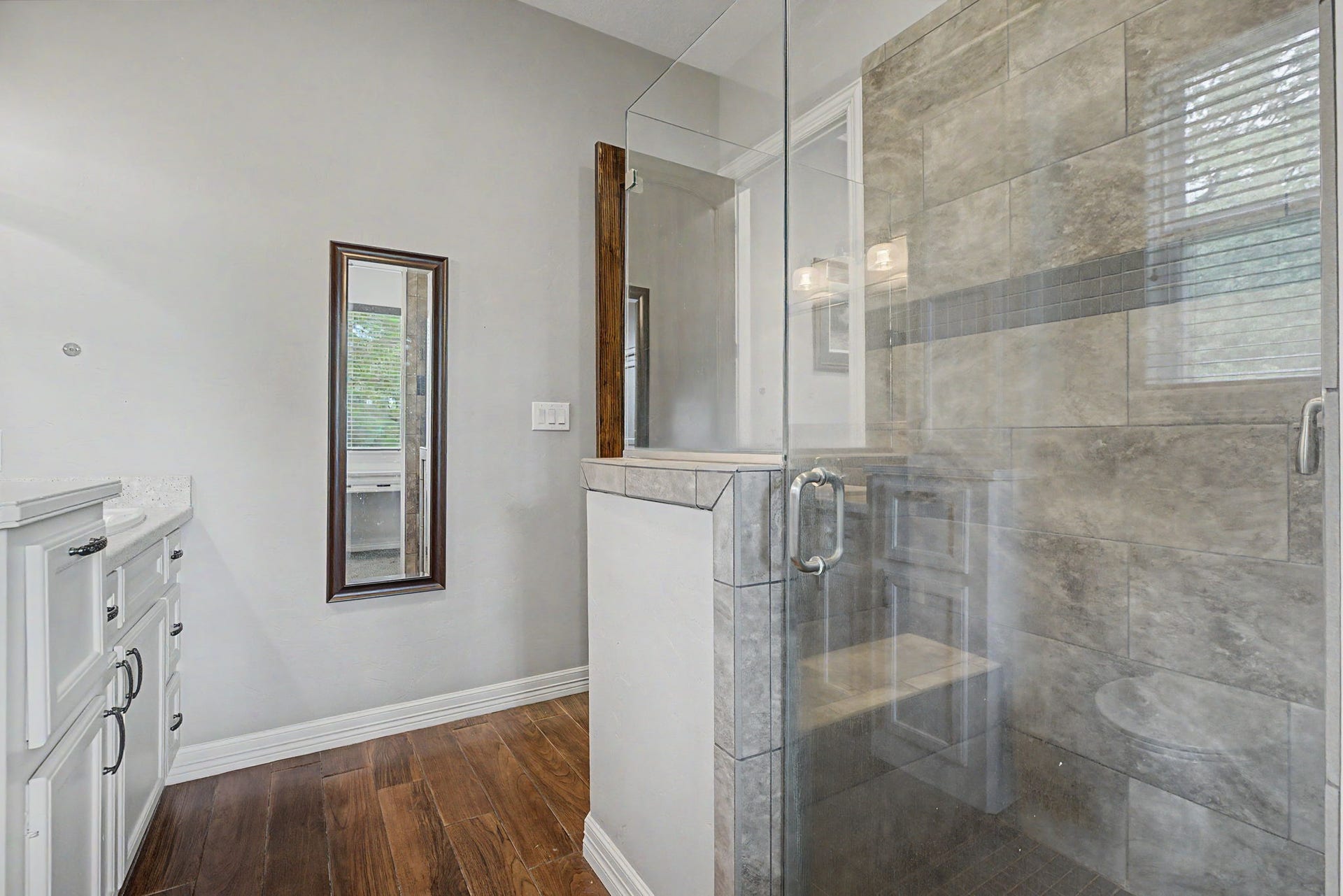 11865 Hope Lane, Magnolia, TX 77354 Enjoy the luxury of this oversized walk-in shower, complete with a built-in bench and beautiful finishes throughout.