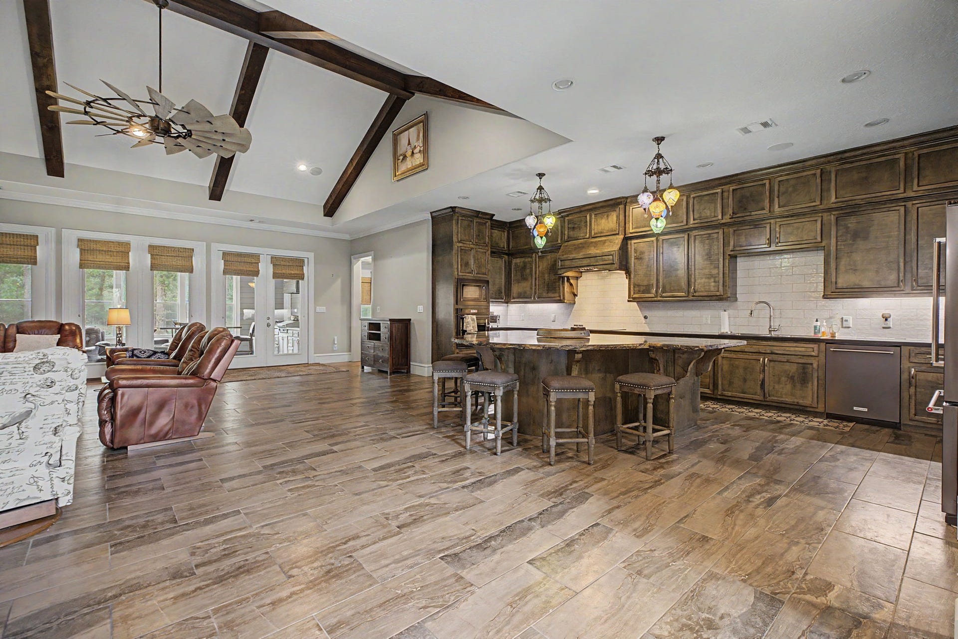 11865 Hope Lane, Magnolia, TX 77354 This view from the kitchen looks toward the private primary suite, highlighting the home's desirable split-floor-plan design, with the primary bedroom thoughtfully separated from the secondary bedrooms.