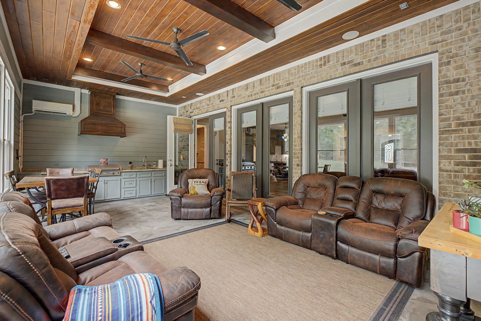11865 Hope Lane, Magnolia, TX 77354 Complete with its own kitchen and separate A/C, this versatile sunroom offers endless possibilities for gatherings, hobbies, or relaxation.