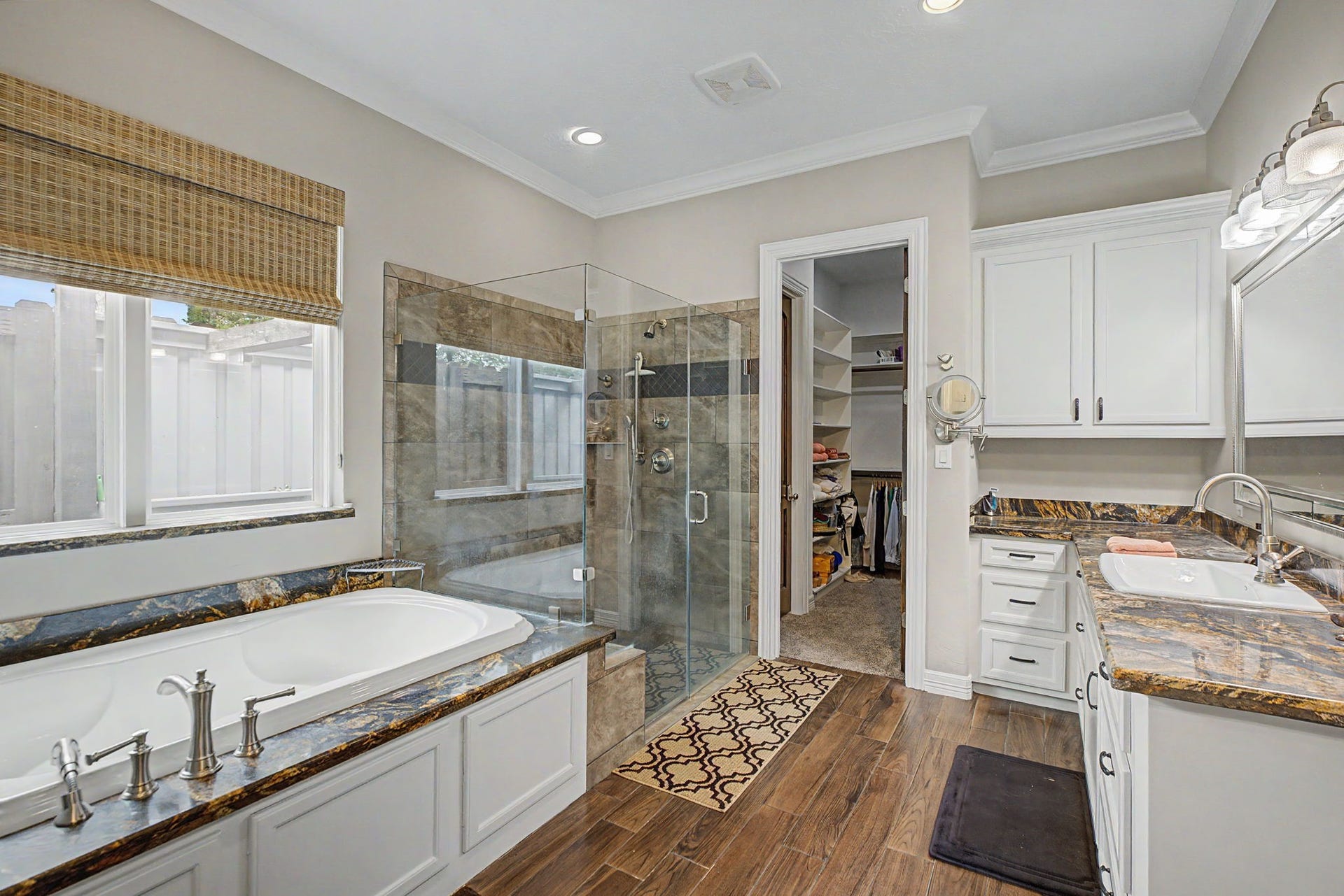11865 Hope Lane, Magnolia, TX 77354 This spacious primary bathroom offers abundant storage and is conveniently connected to TWO large walk-in closets for added functionality and ease.