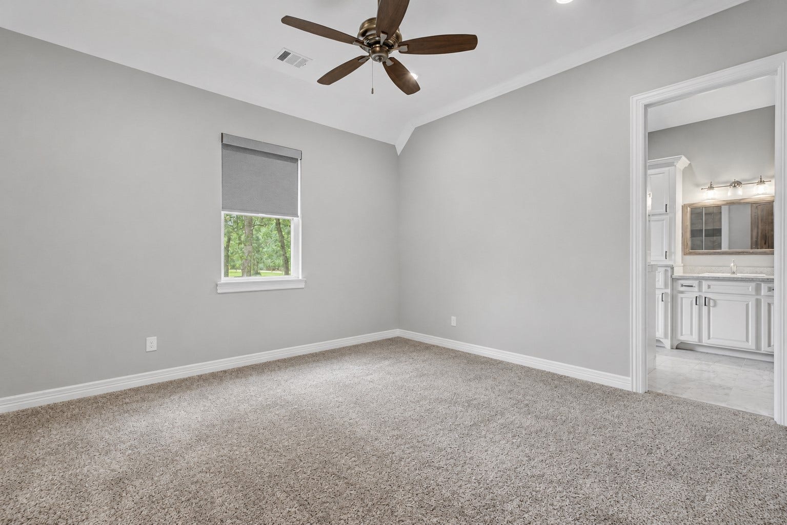 11865 Hope Lane, Magnolia, TX 77354 This generously sized Secondary Bedroom #1 includes its own ensuite bathroom and a large walk-in closet, making it ideal for guests or family members.