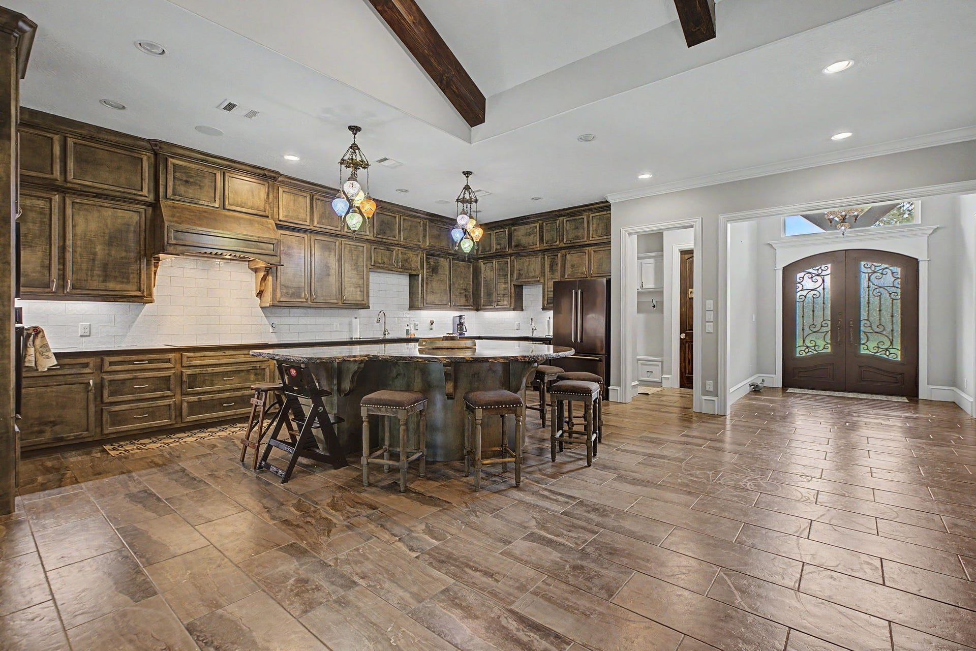 11865 Hope Lane, Magnolia, TX 77354 This view of the kitchen showcases the custom cabinetry and abundant storage space, offering both beauty and functionality.
