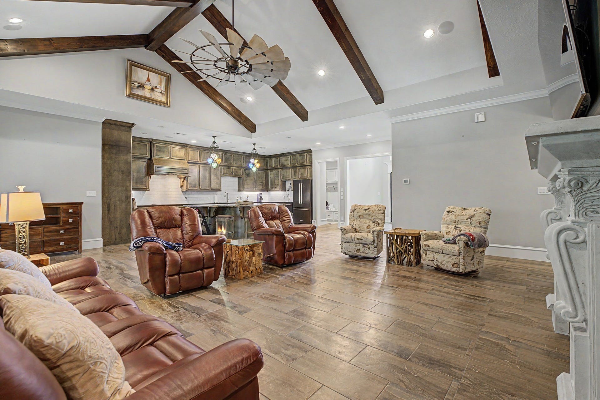 11865 Hope Lane, Magnolia, TX 77354 View from the living room into the kitchen, showcasing the stunning vaulted ceilings and open-concept design.