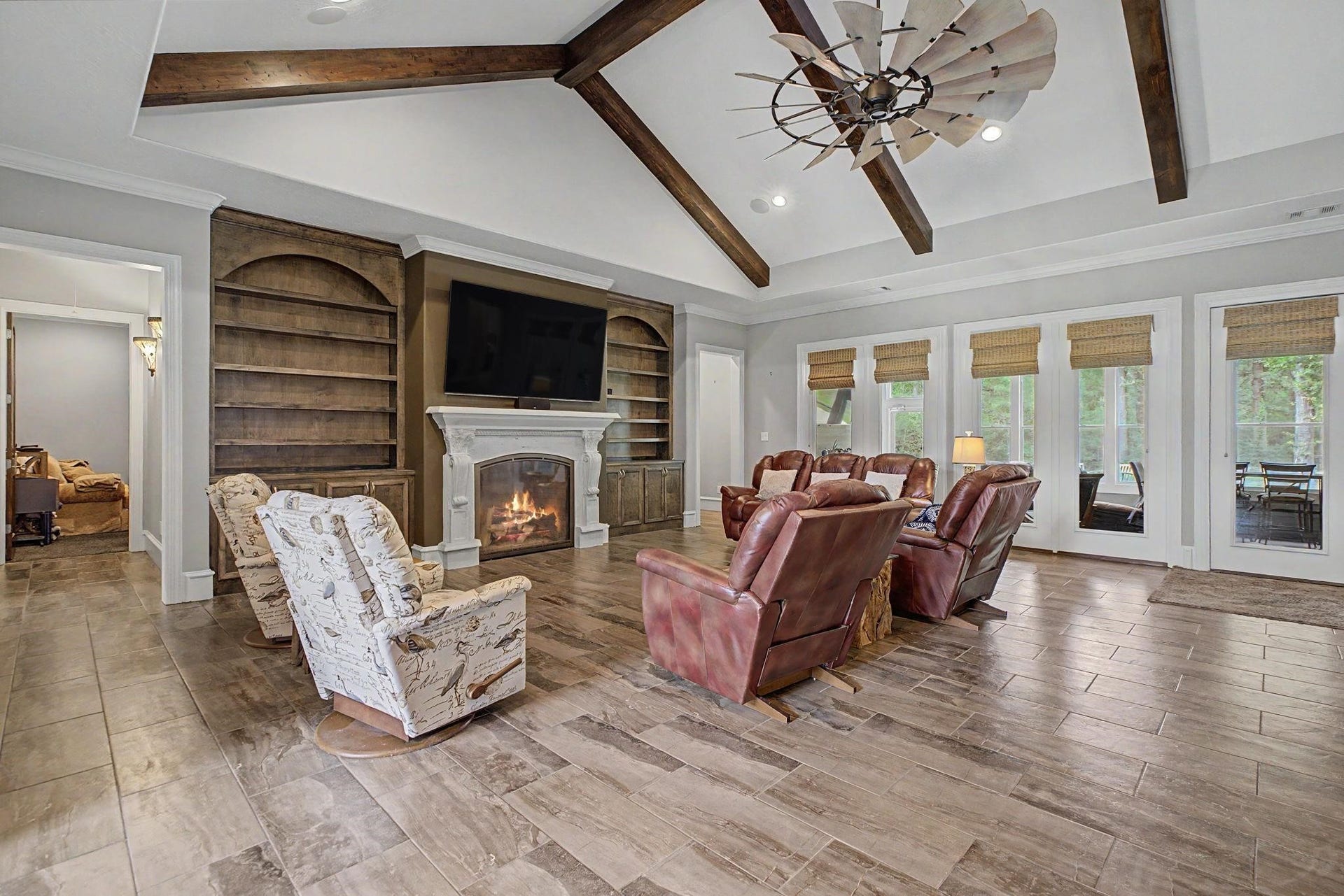 11865 Hope Lane, Magnolia, TX 77354 Your New Favorite Spot - Relax by the gas fireplace surrounded by stylish living room built-ins, perfect for year-round comfort.