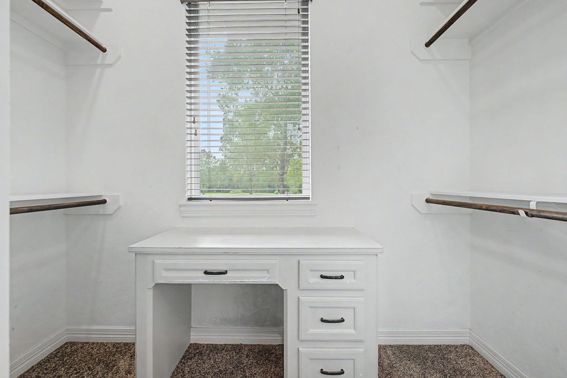 11865 Hope Lane, Magnolia, TX 77354 This spacious walk-in closet for Secondary Bedroom #1 features a built-in desk and a window that fills the space with natural light.