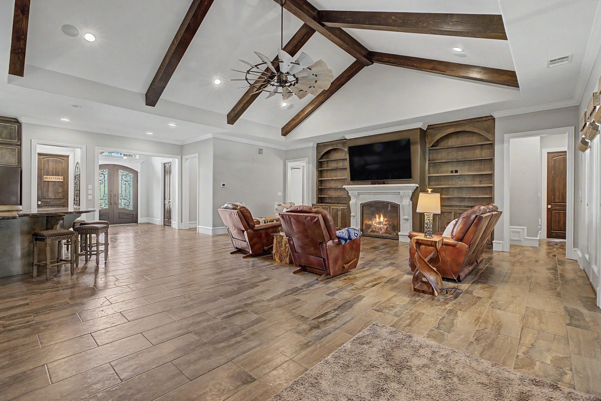 11865 Hope Lane, Magnolia, TX 77354 This view from the living room captures the connection between the kitchen and foyer, creating a bright and welcoming living space.