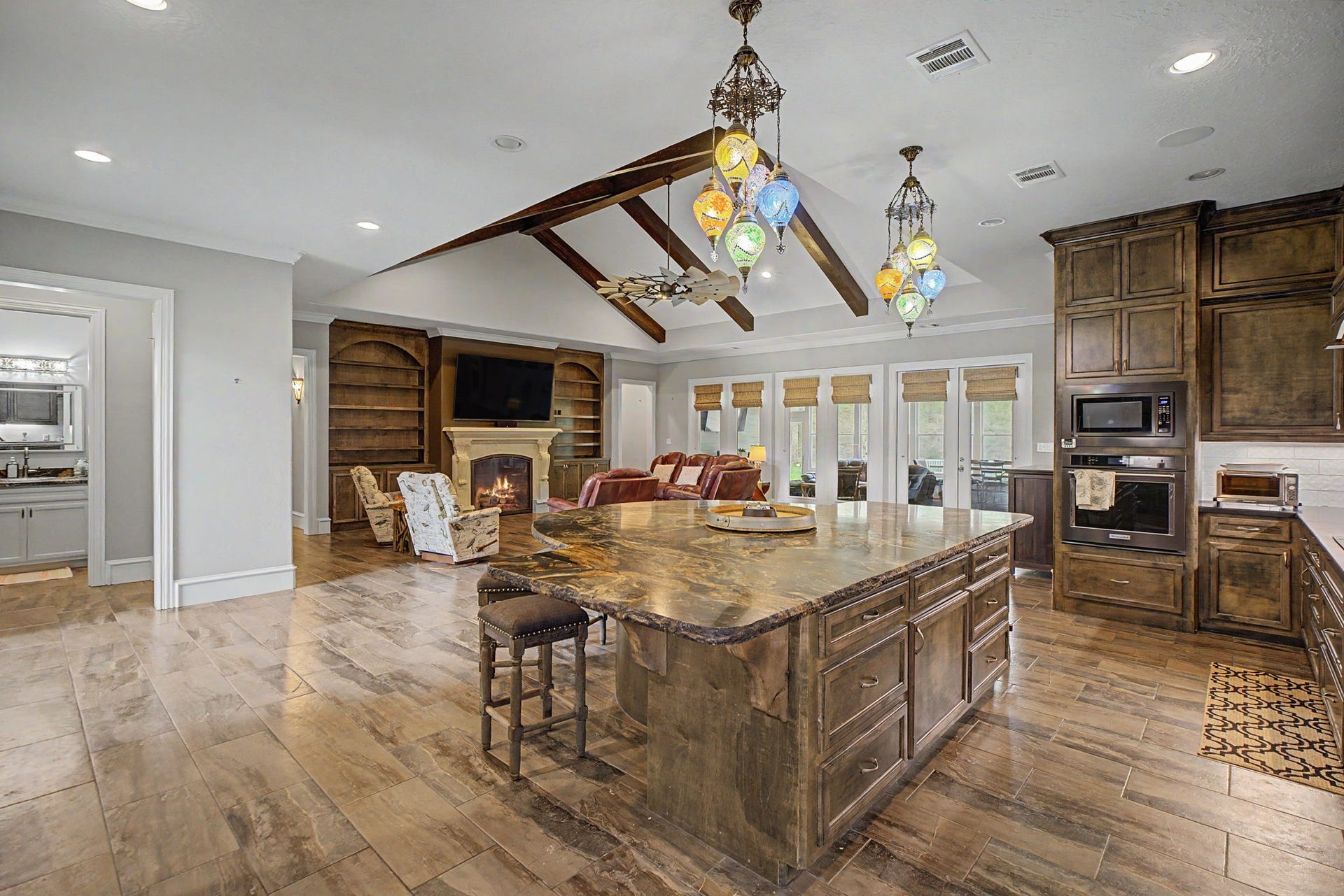 11865 Hope Lane, Magnolia, TX 77354 Take a look at the oversized kitchen island, featuring gorgeous granite countertops and stunning imported light fixtures that add a touch of elegance.