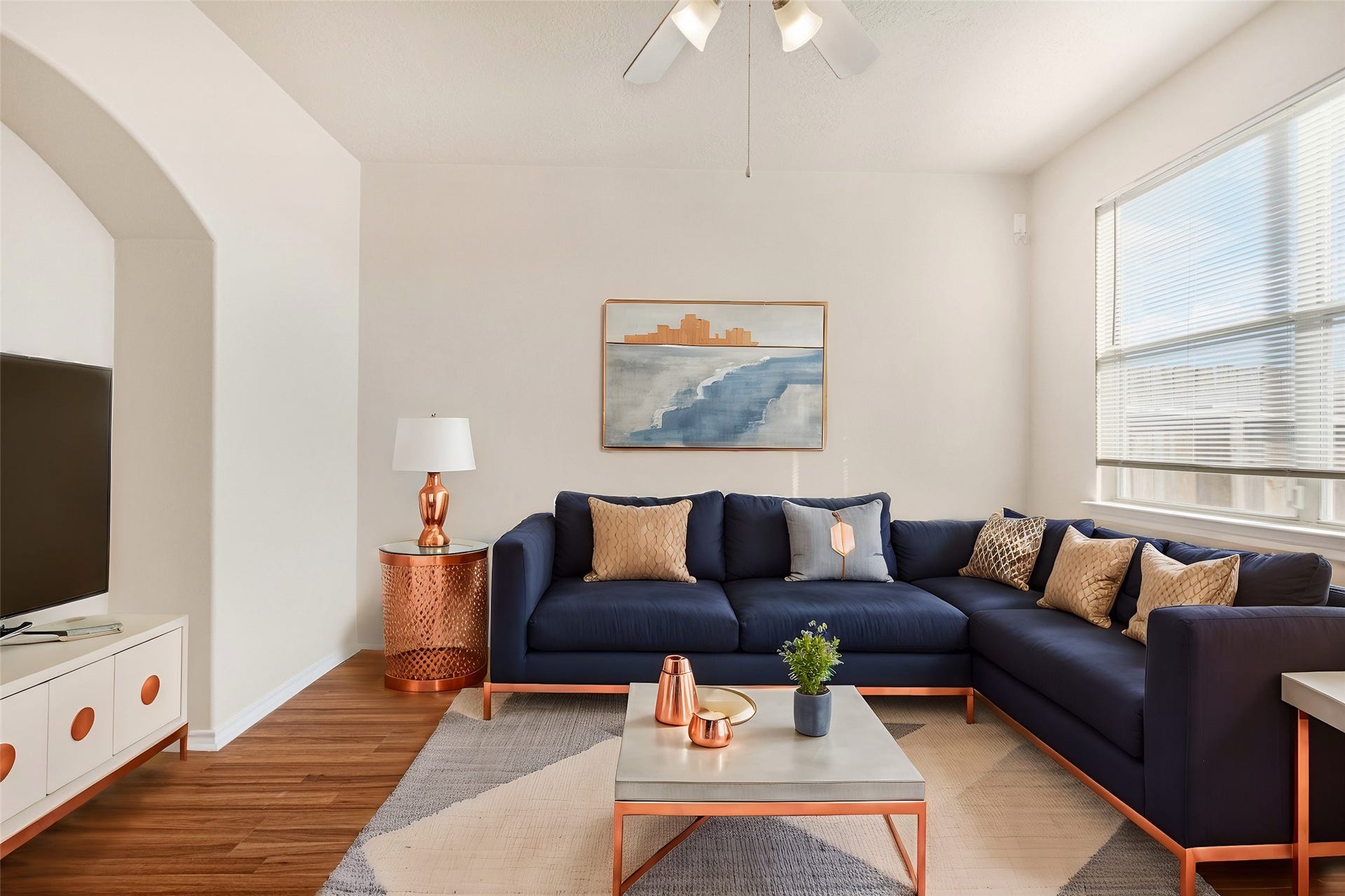 3412 Orchid Trace Lane, Houston, TX 77047 The living area has sleek wood-like laminate floors, large window, and a ceiling fan, creating a welcoming atmosphere *virtually staged*