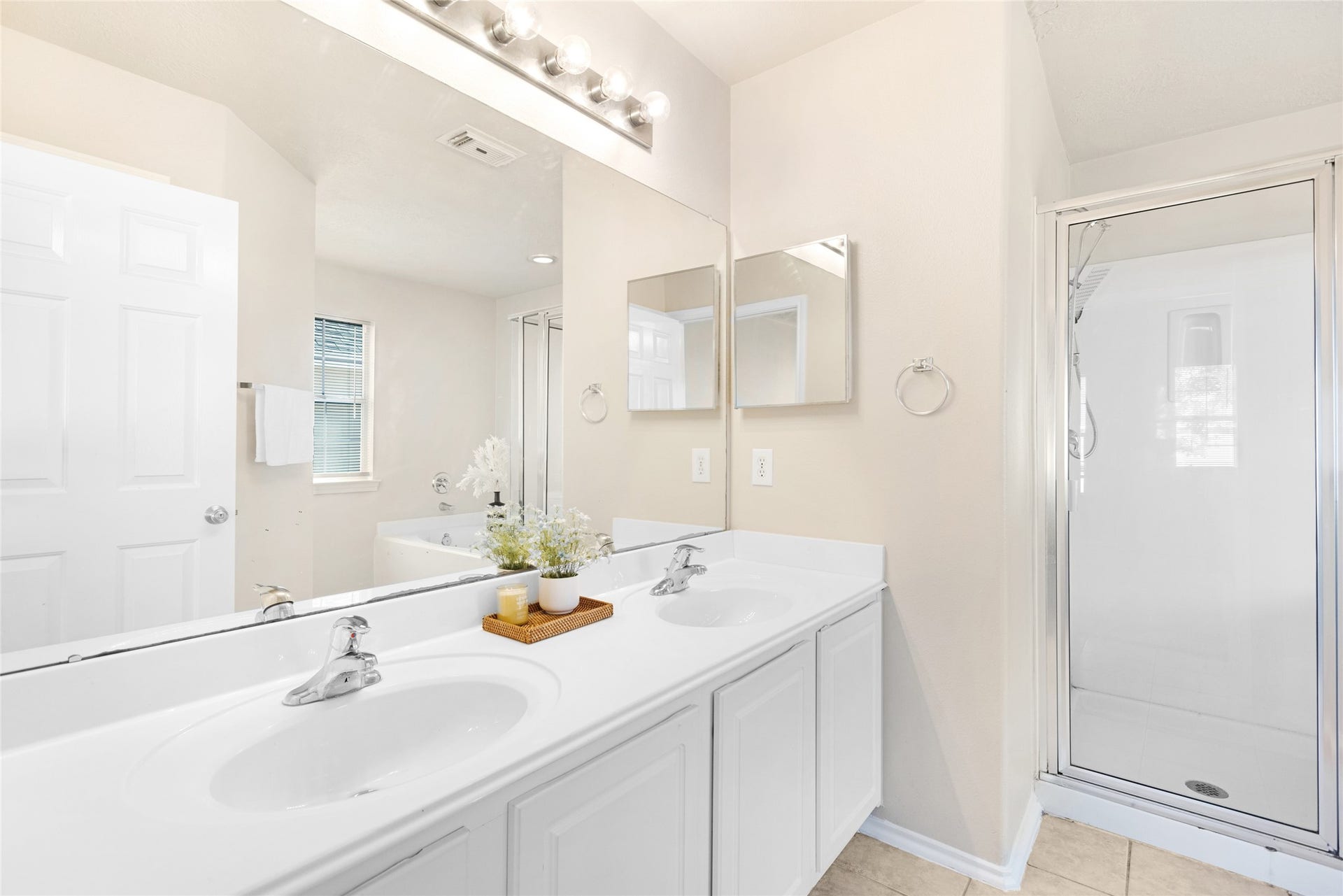 3412 Orchid Trace Lane, Houston, TX 77047 Spa-like primary bathroom features a double-sink vanity, large mirror, glass-enclosed shower