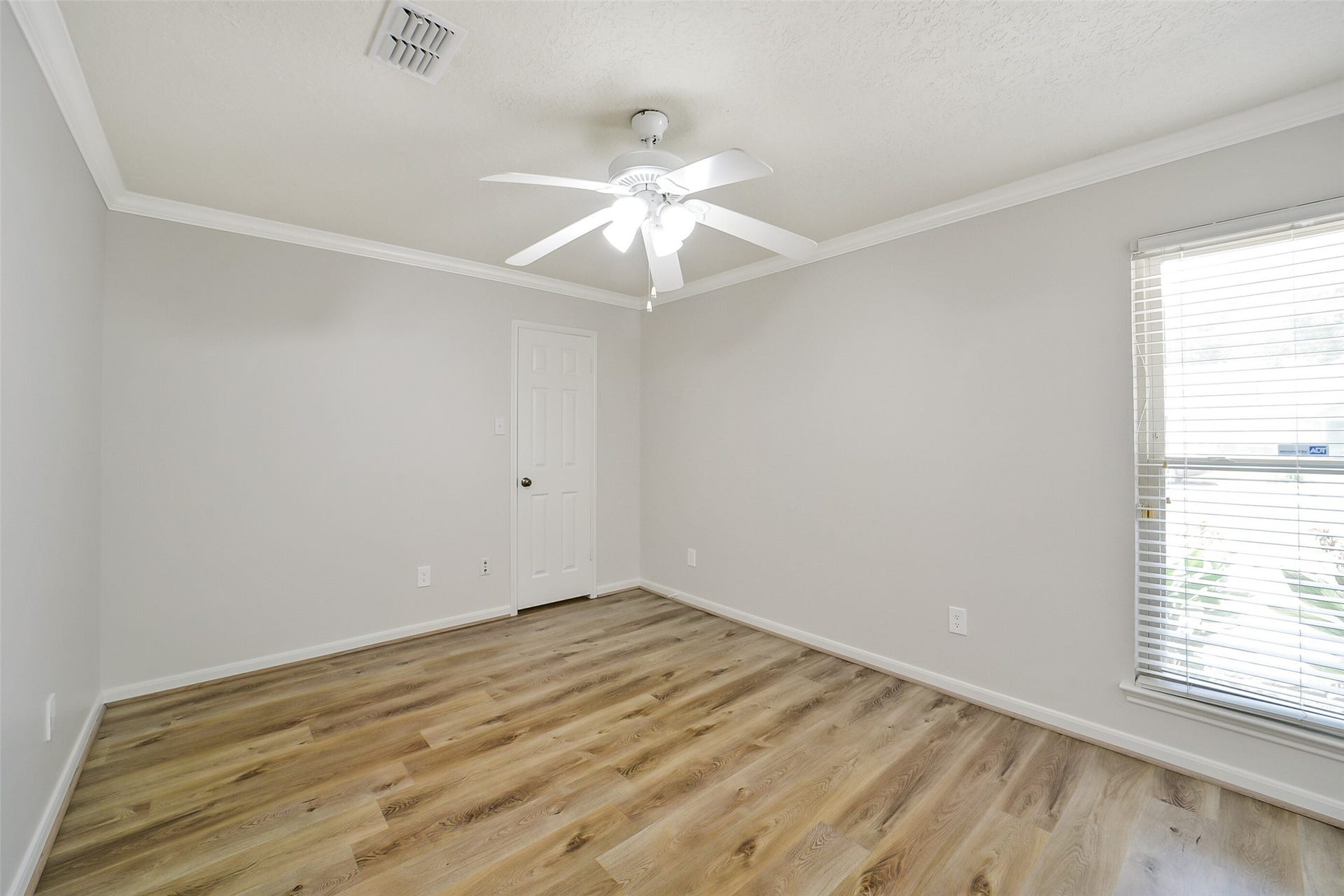 Bedroom #2 has high end laminate floors, crown molding, a ceiling fan and walk-in closet.