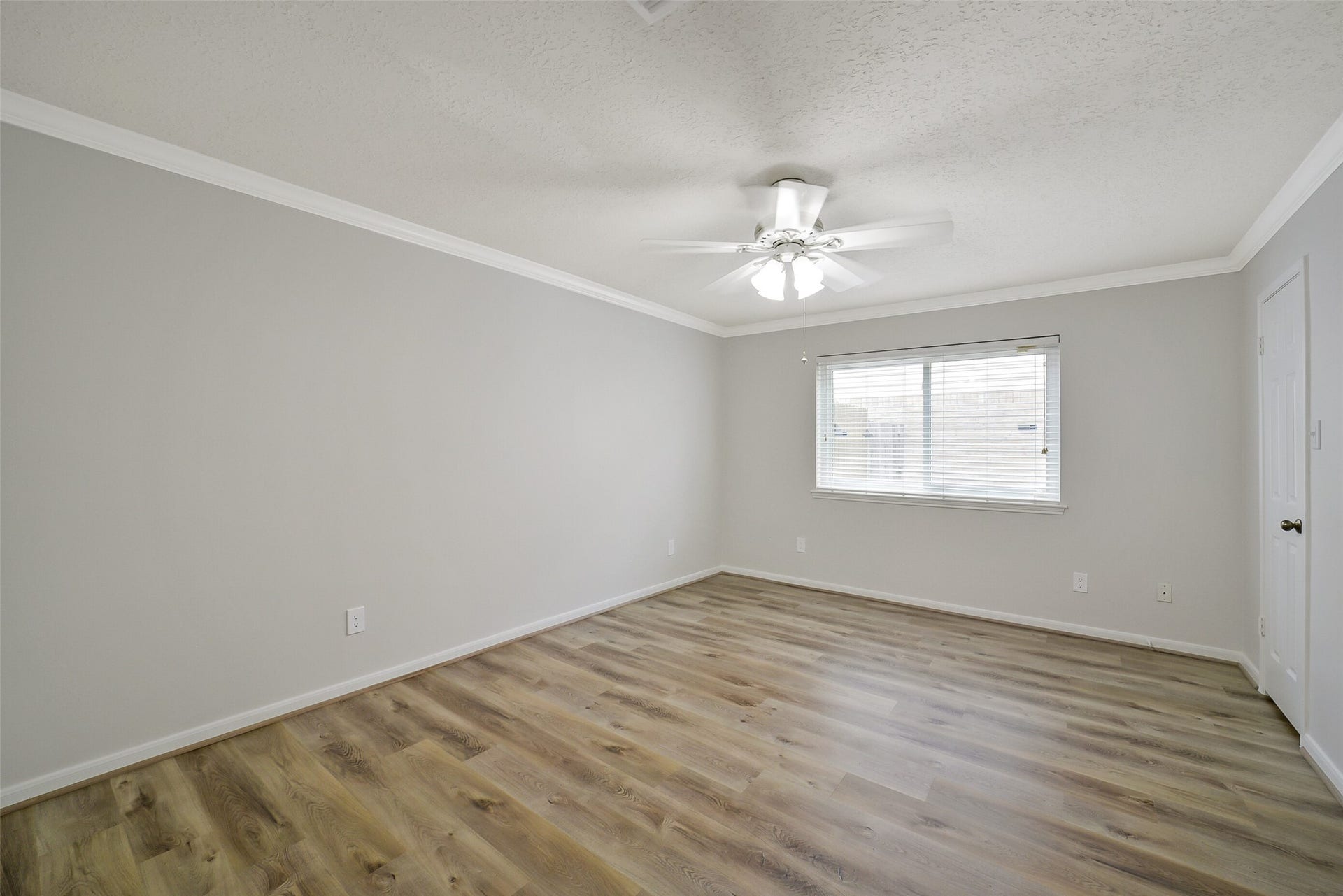 The very spacious bedroom #3 features crown molding, a ceiling fan and walk-in closet.