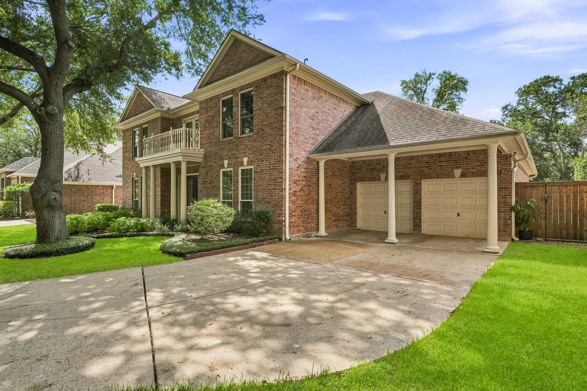 Impeccable landscaping. A three-car tandem garage and double wide driveway provides plenty of space for parking.