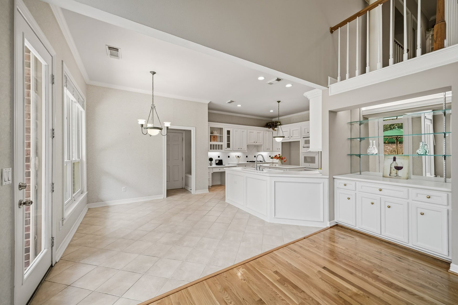A large breakfast area and dry bar area with glass shelving.