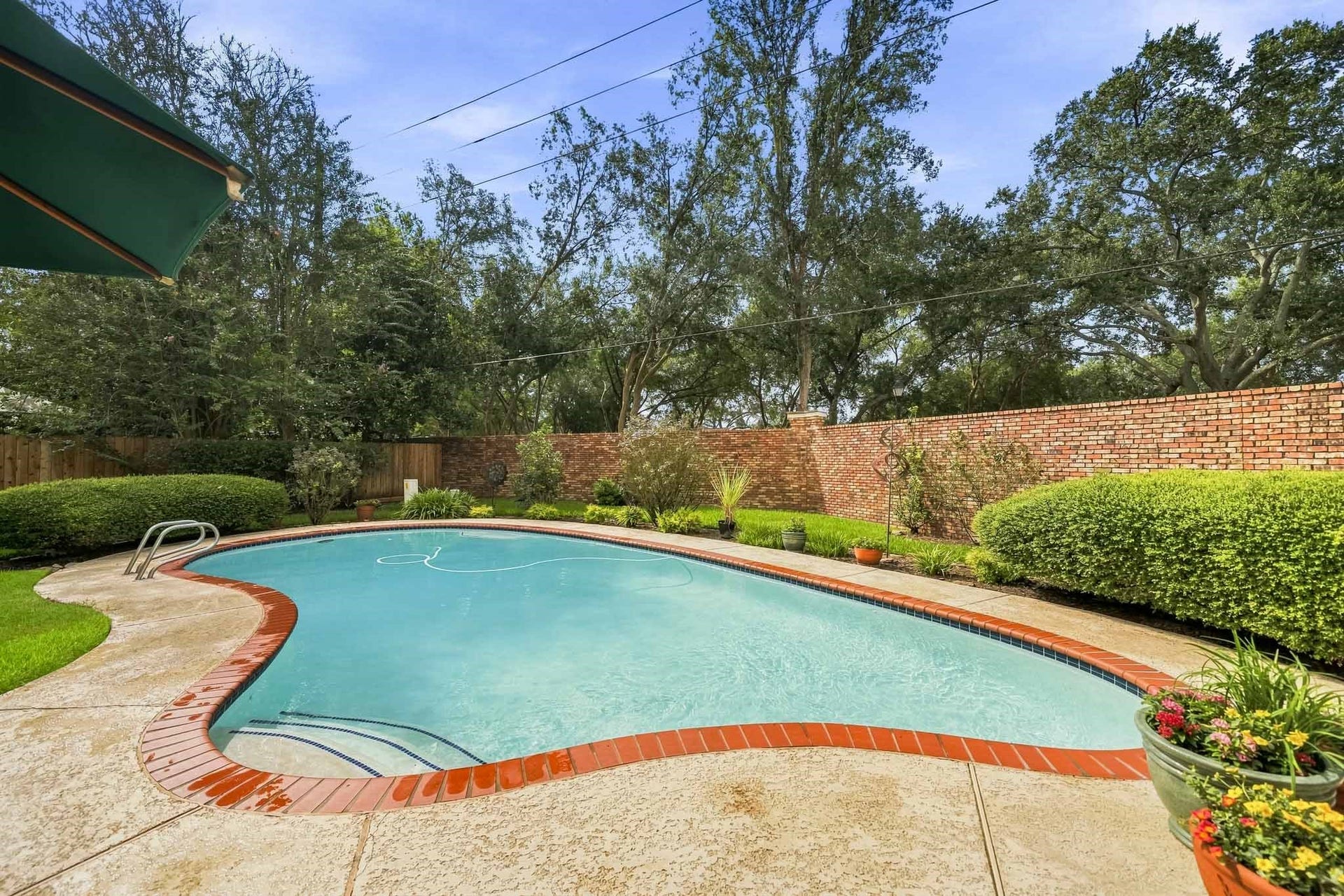 The home is situated on a large private lot with a sparkling pool and lovely landscaping.