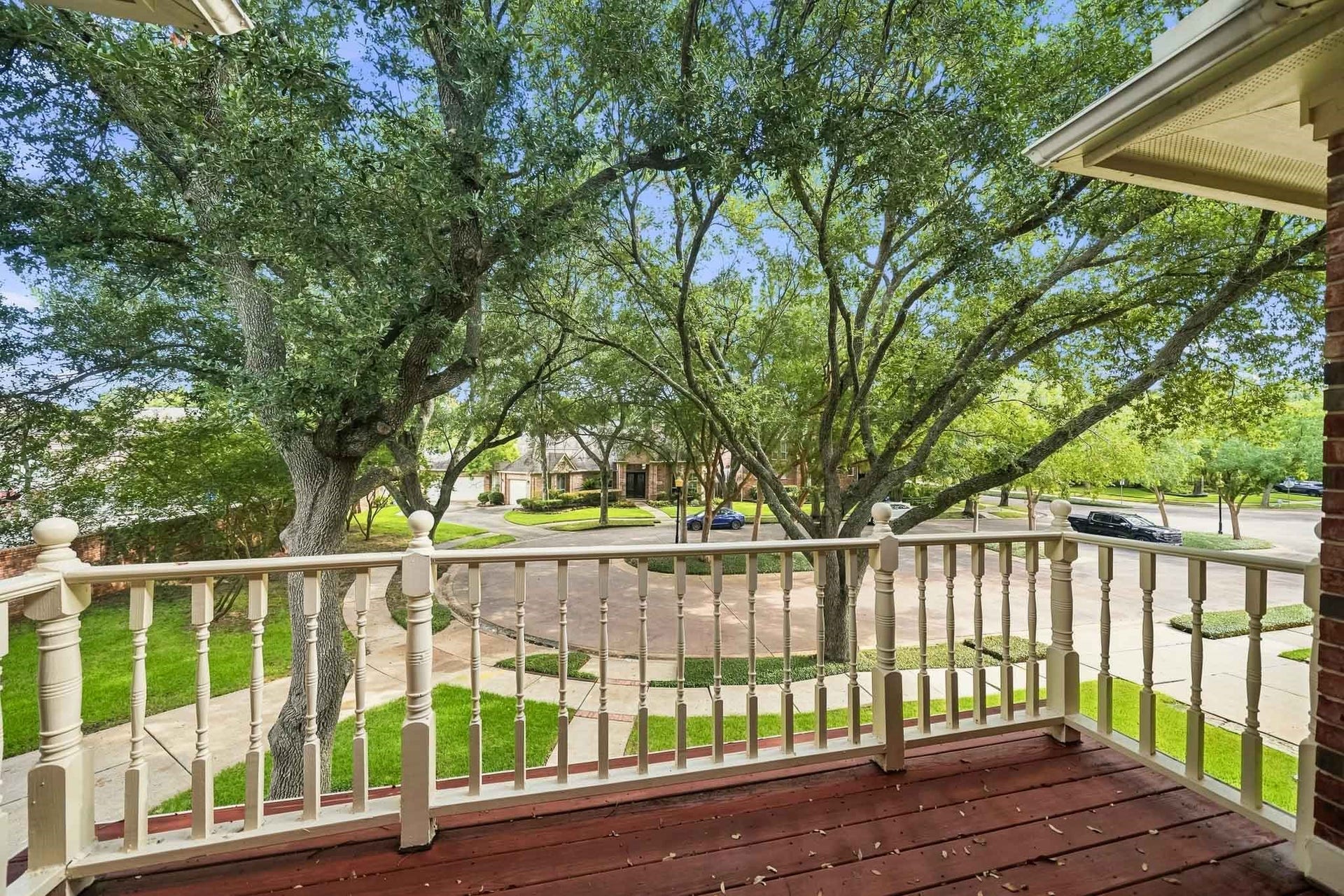 The balcony overlooks the front yard with lovely mature trees.