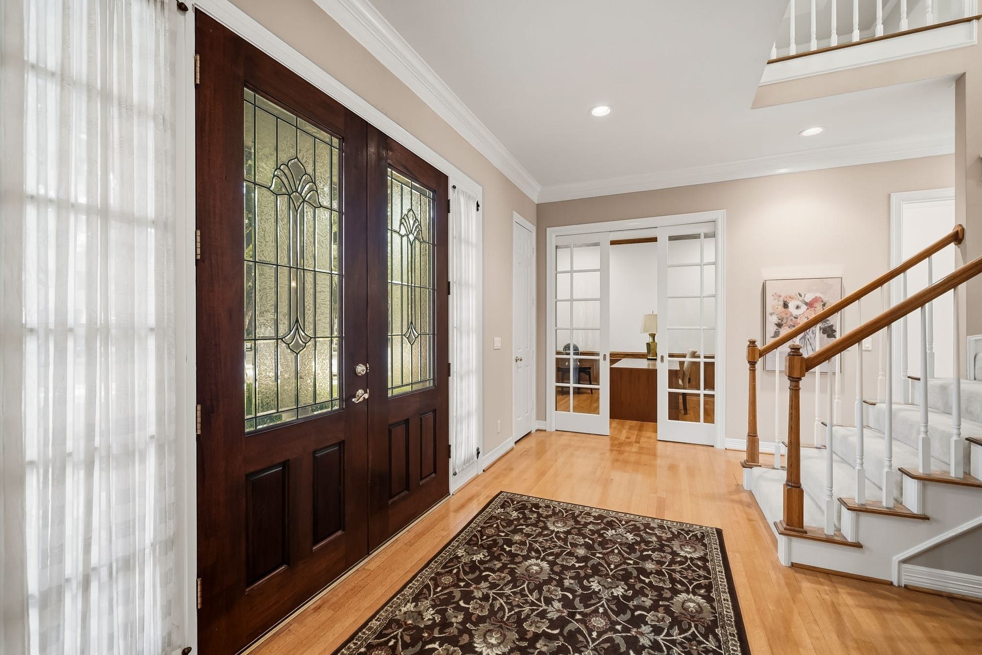To the left upon entry is the spacious home office with gorgeous French pocket doors.