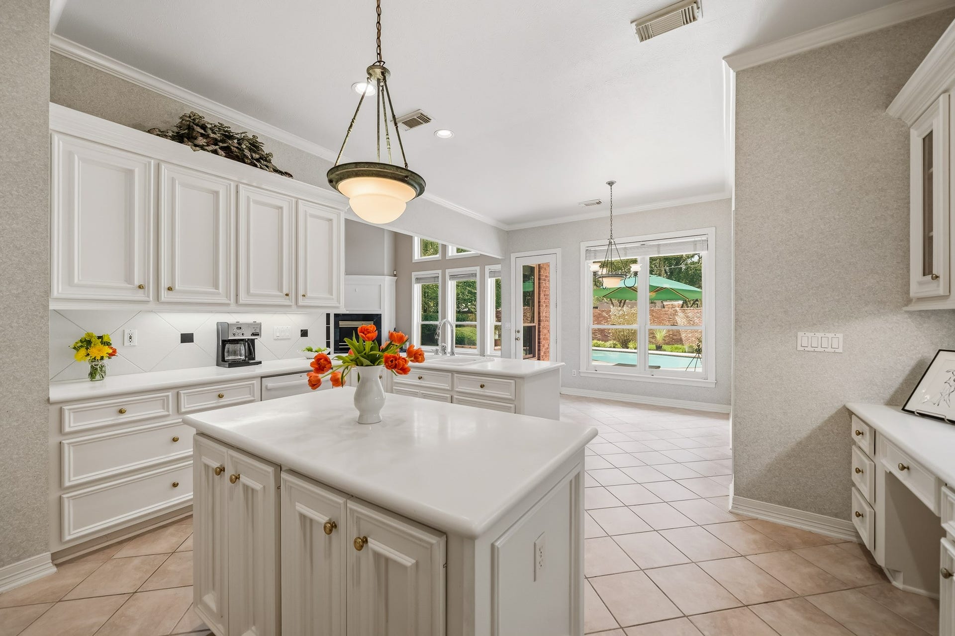 A large island for prep. This spacious kitchen will be a favorite place to hang out, cook and entertain. The breakfast area overlooks the pristine pool and lush backyard.