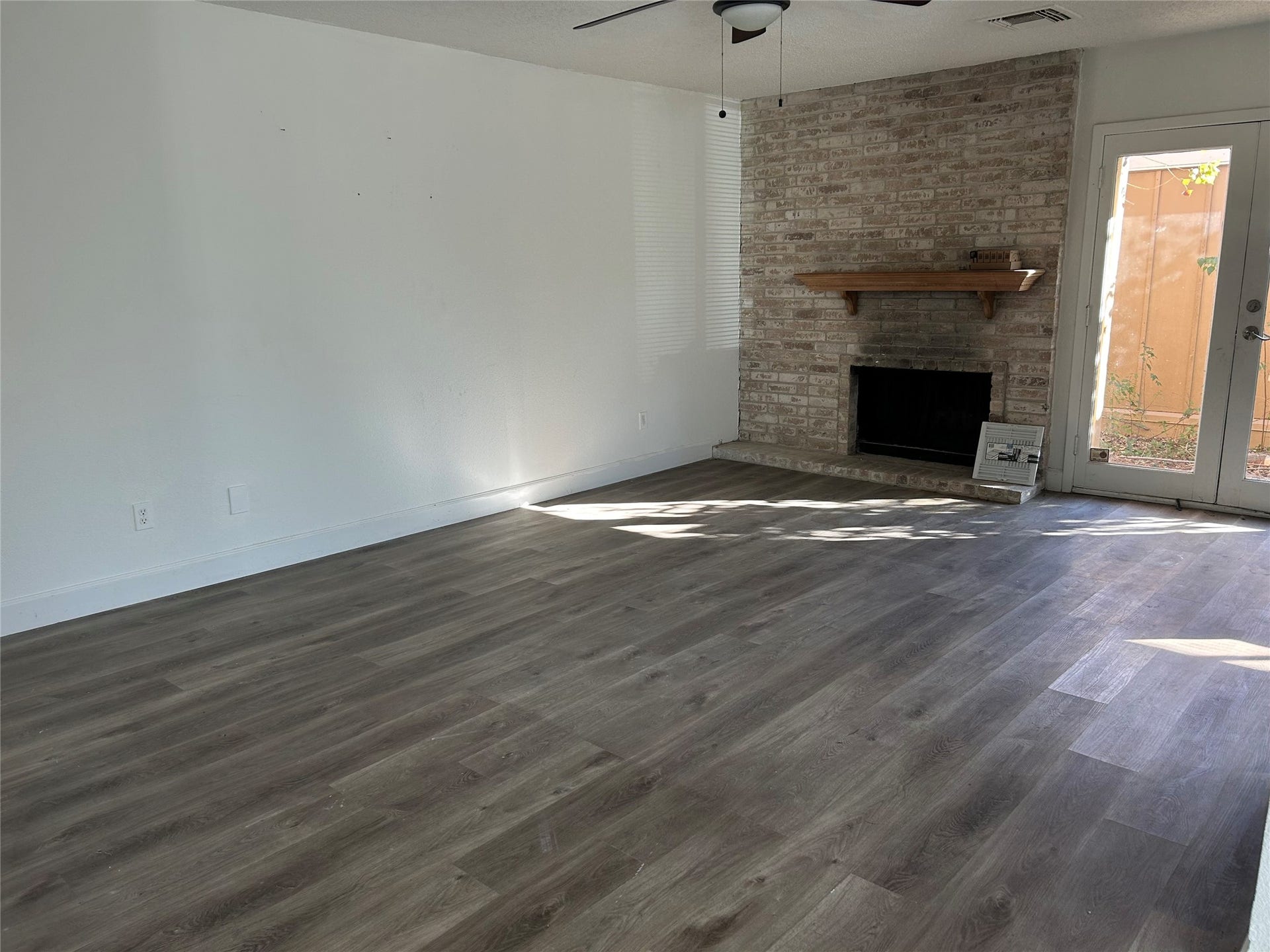 6119 Dryad Drive, Houston, TX 77035 Spacious family room with a lovely fireplace and ceiling fan.