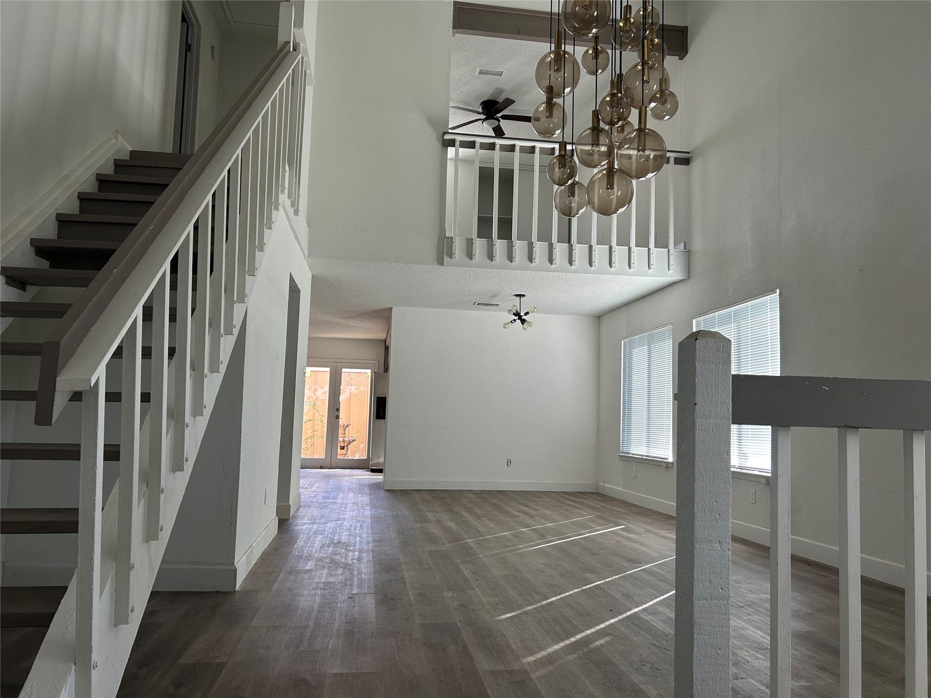 6119 Dryad Drive, Houston, TX 77035 Expansive living room, dining area with high ceiling and large windows for natural light.