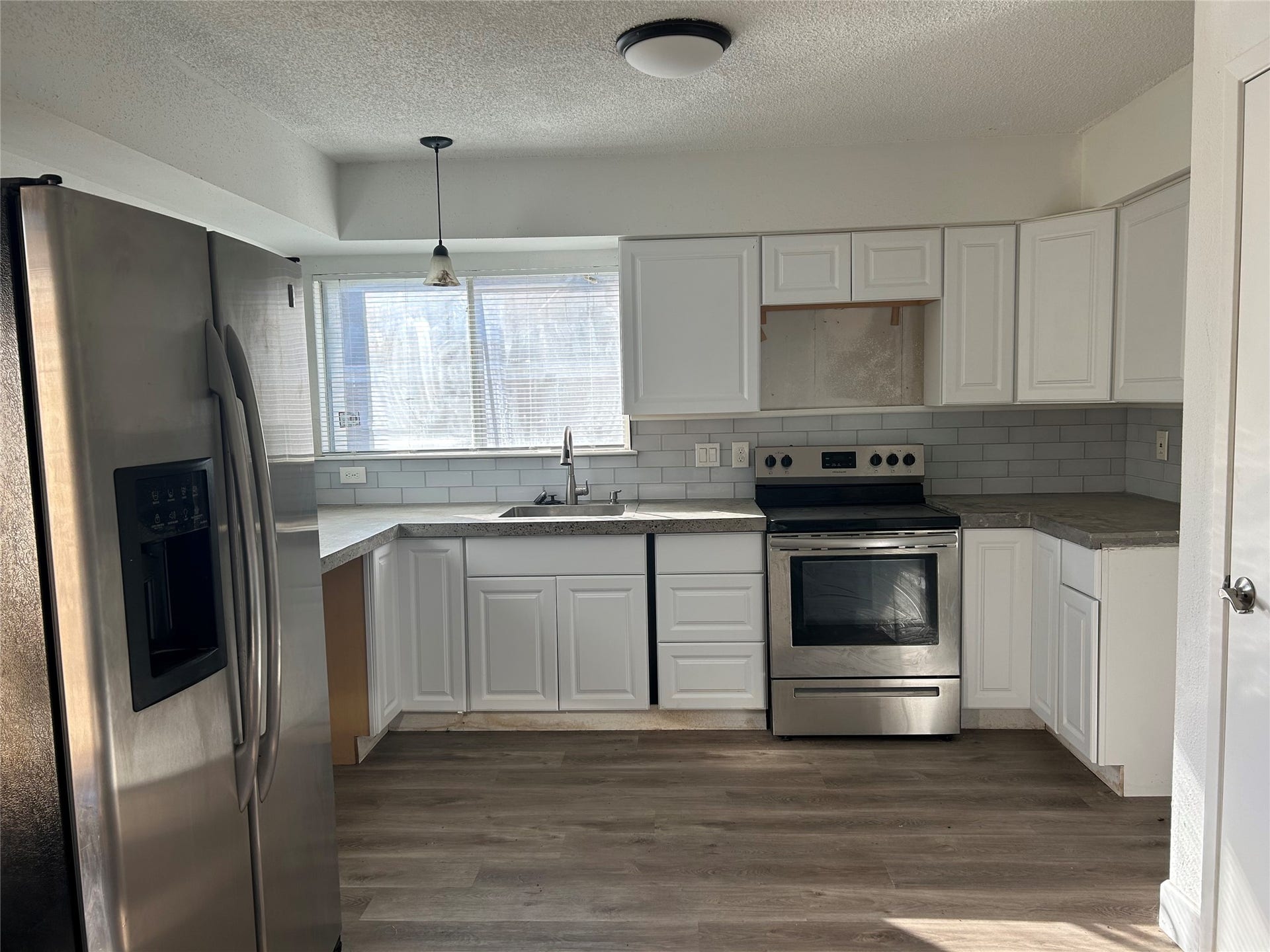 6119 Dryad Drive, Houston, TX 77035 Beautiful kitchen with abundant cabinets and window by the sink.