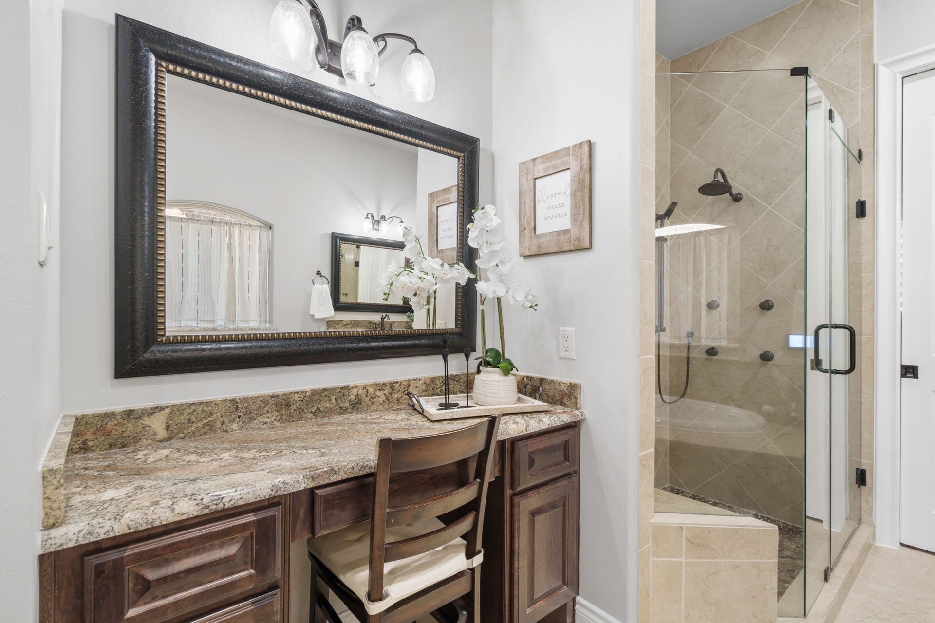 126 Summer Holly Drive, Conroe, TX 77384 Dedicated makeup vanity with generous counter space alongside an oversized, glass-enclosed shower.