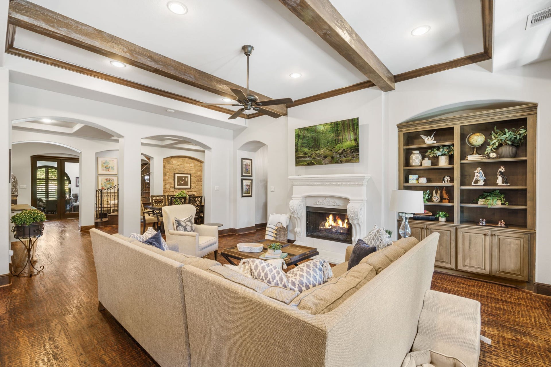 126 Summer Holly Drive, Conroe, TX 77384 Beautifully detailed fireplace with an ornate mantel creates an inviting focal point, complemented by custom built-in cabinetry.