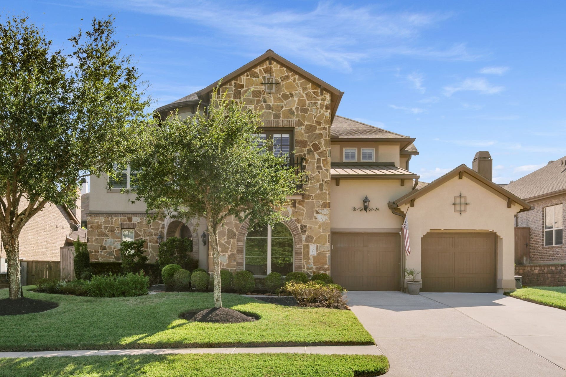 126 Summer Holly Drive, Conroe, TX 77384 Distinctive stone and stucco architecture accented by a charming Juliet balcony with decorative wrought iron railing.