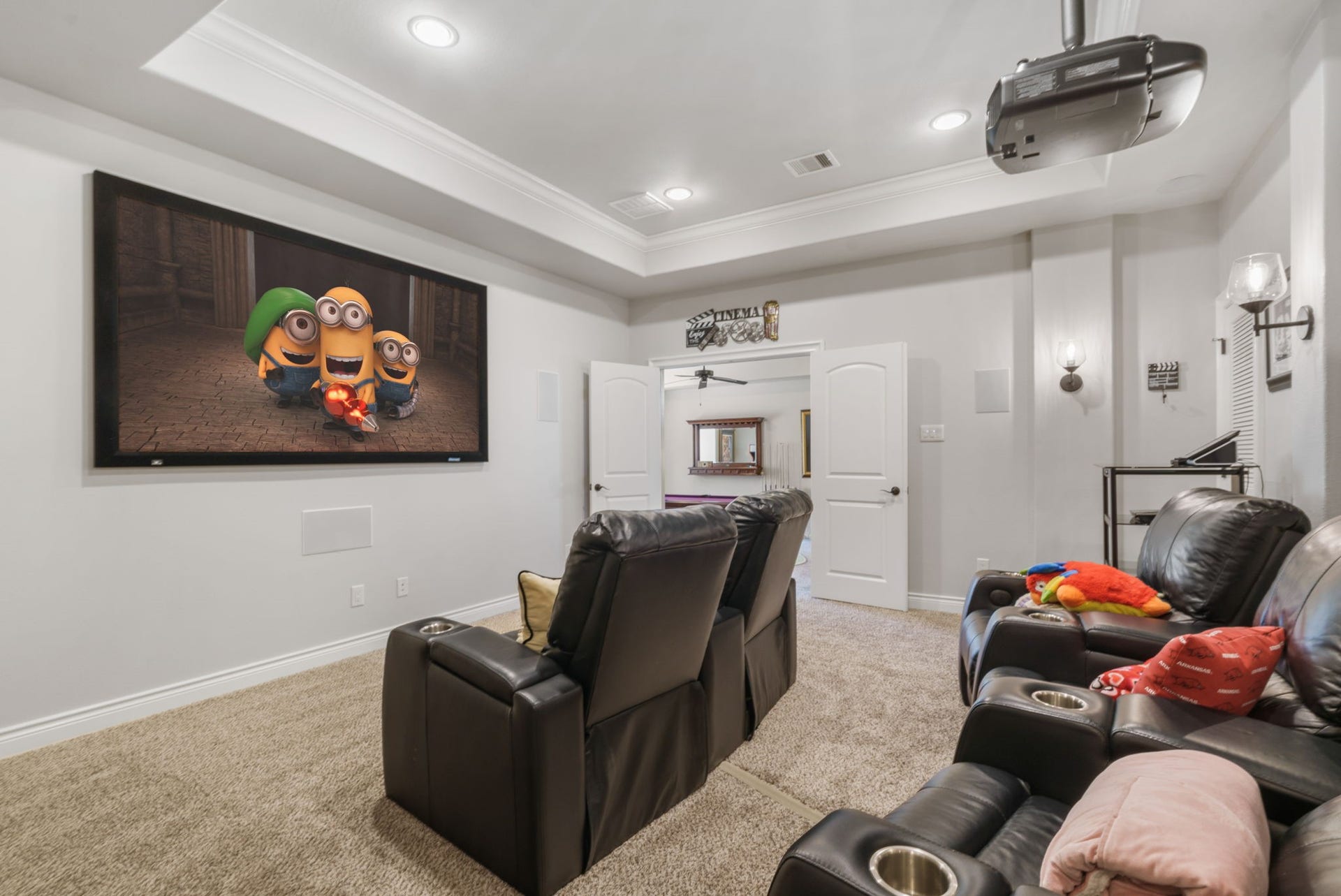 126 Summer Holly Drive, Conroe, TX 77384 Enjoy the full theater experience with a large projection screen, built-in speakers, and double doors connecting to the game room.