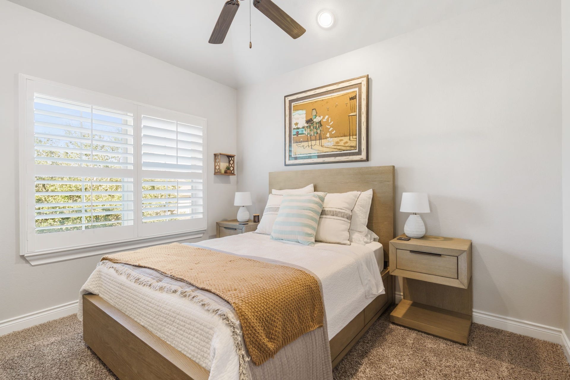 126 Summer Holly Drive, Conroe, TX 77384 Bright and inviting secondary bedroom with generous natural light, plantation shutters, and a ceiling fan.