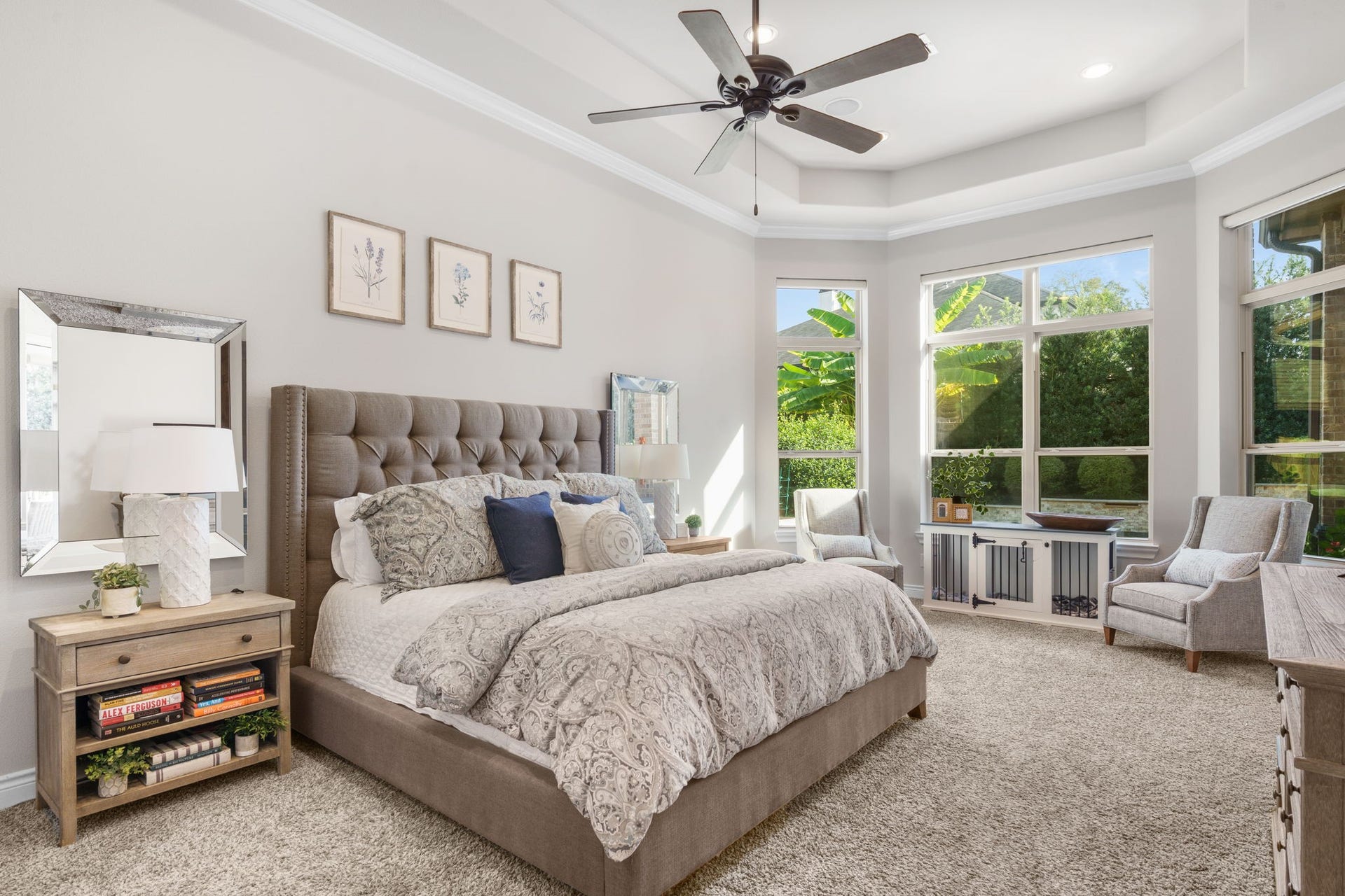 126 Summer Holly Drive, Conroe, TX 77384 Spacious primary retreat featuring a tray ceiling, crown molding, and a beautiful wall of windows overlooking the backyard.