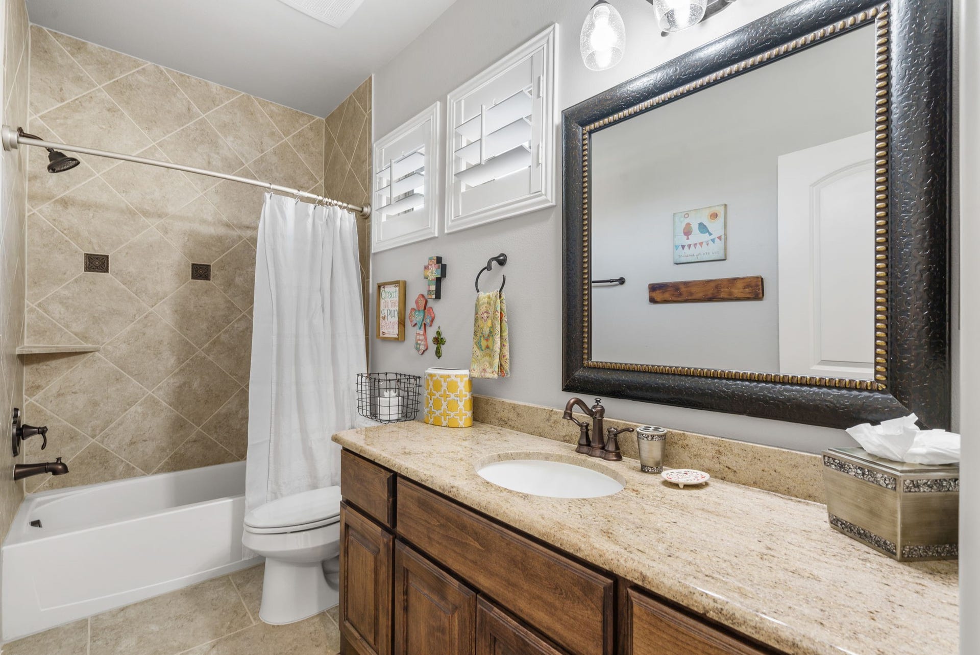 126 Summer Holly Drive, Conroe, TX 77384 Well-appointed full bathroom featuring granite countertops, rich wood cabinetry, a tub/shower combination, and plantation shutters.