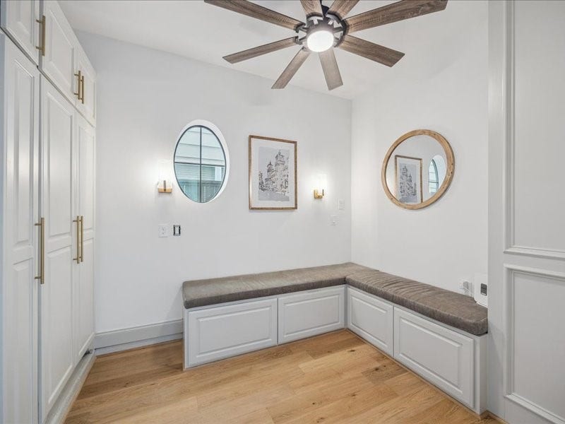 This inviting breakfast room sits between the kitchen and garage, featuring a built-in banquette, shelving, and extra storage. Just add a table for the perfect spot to enjoy morning coffee, casual meals, or dinner with friends!