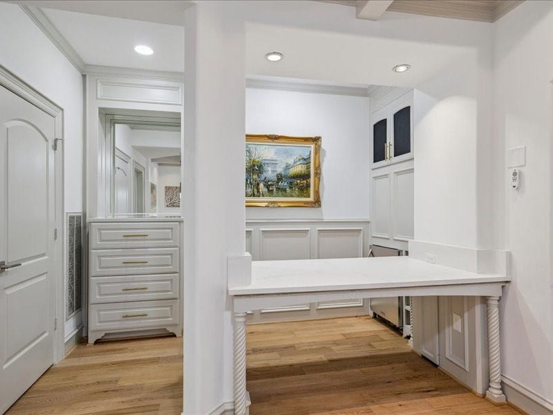 Smart design meets everyday convenience! This built-in workspace in the living area features a stainless steel beverage fridge and plenty of extra storage. Thoughtful built-ins keep essentials organized while reducing the need for additional furniture.