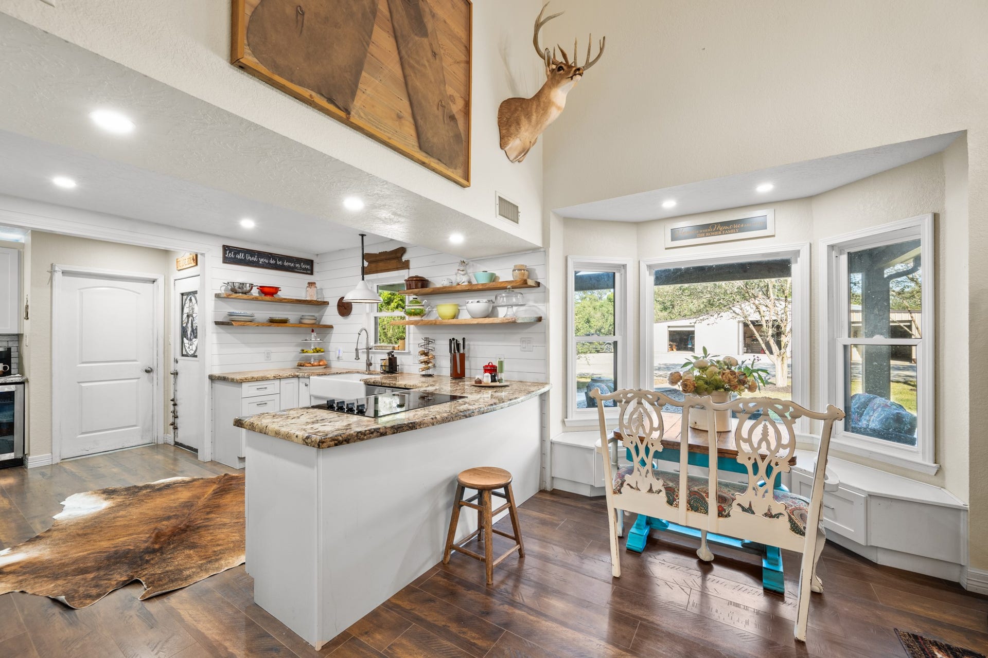 2215 Avenue Q, Santa Fe, TX 77510 Soaring ceilings and a light-filled breakfast nook with built-in bench seating create an inviting space to gather while enjoying views of the outdoors.