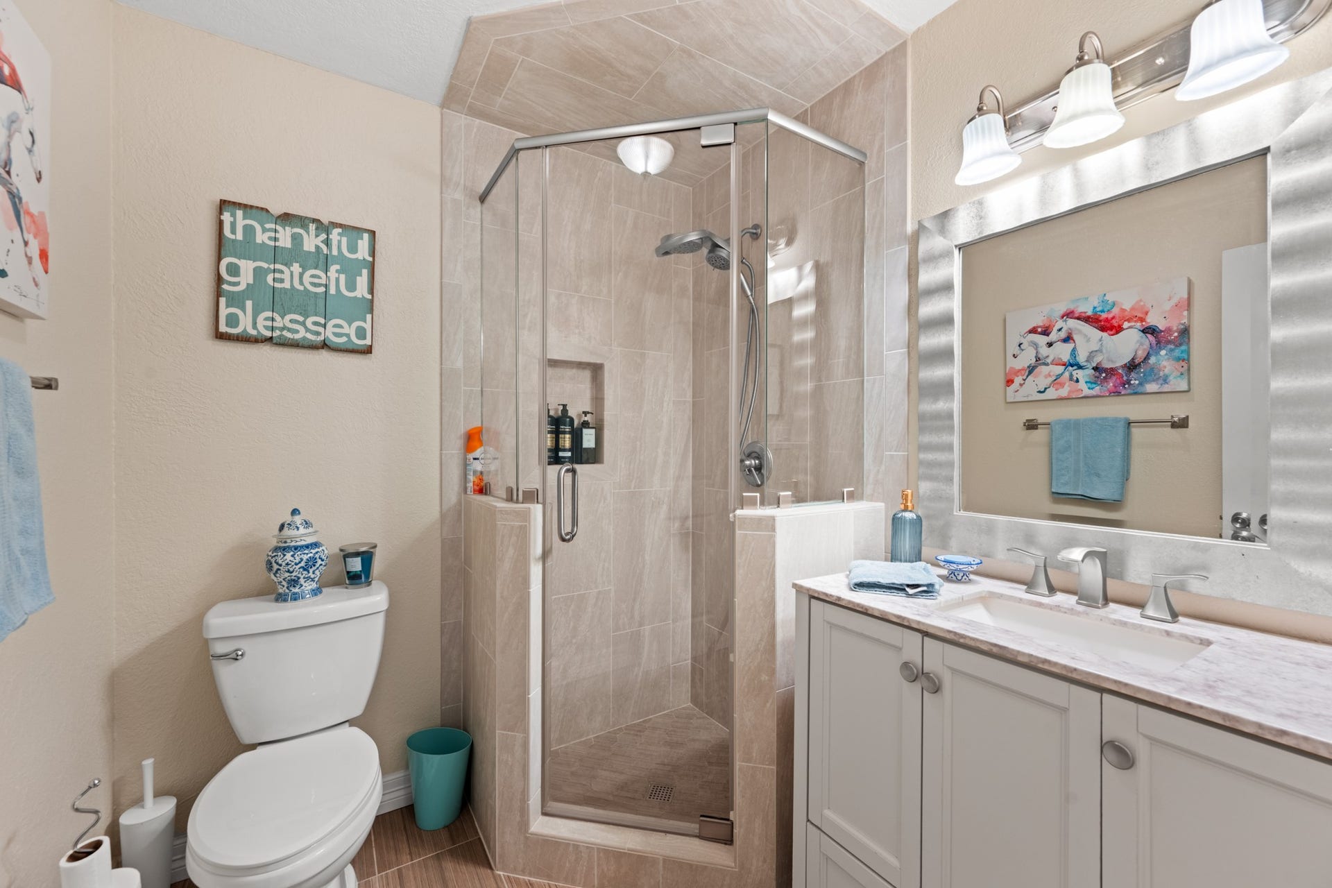 2215 Avenue Q, Santa Fe, TX 77510 Beautifully appointed bathroom features a glass-enclosed tiled shower with built-in niche, a spacious vanity, brushed-nickel fixtures, and contemporary finishes.