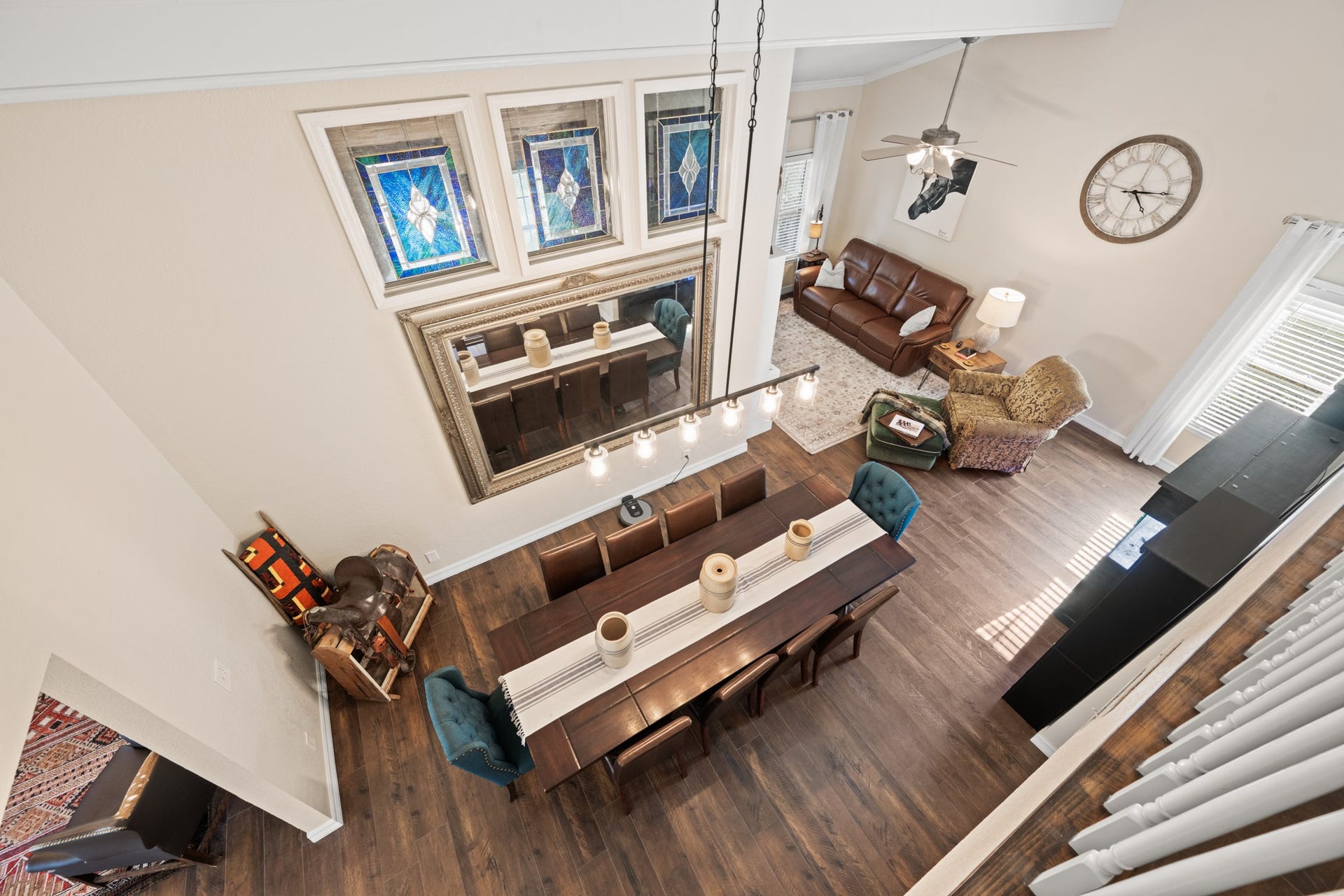 2215 Avenue Q, Santa Fe, TX 77510 An impressive view from above showcases the home's soaring ceilings, open dining and family room layout, decorative stained-glass windows, and warm wood-look flooring.