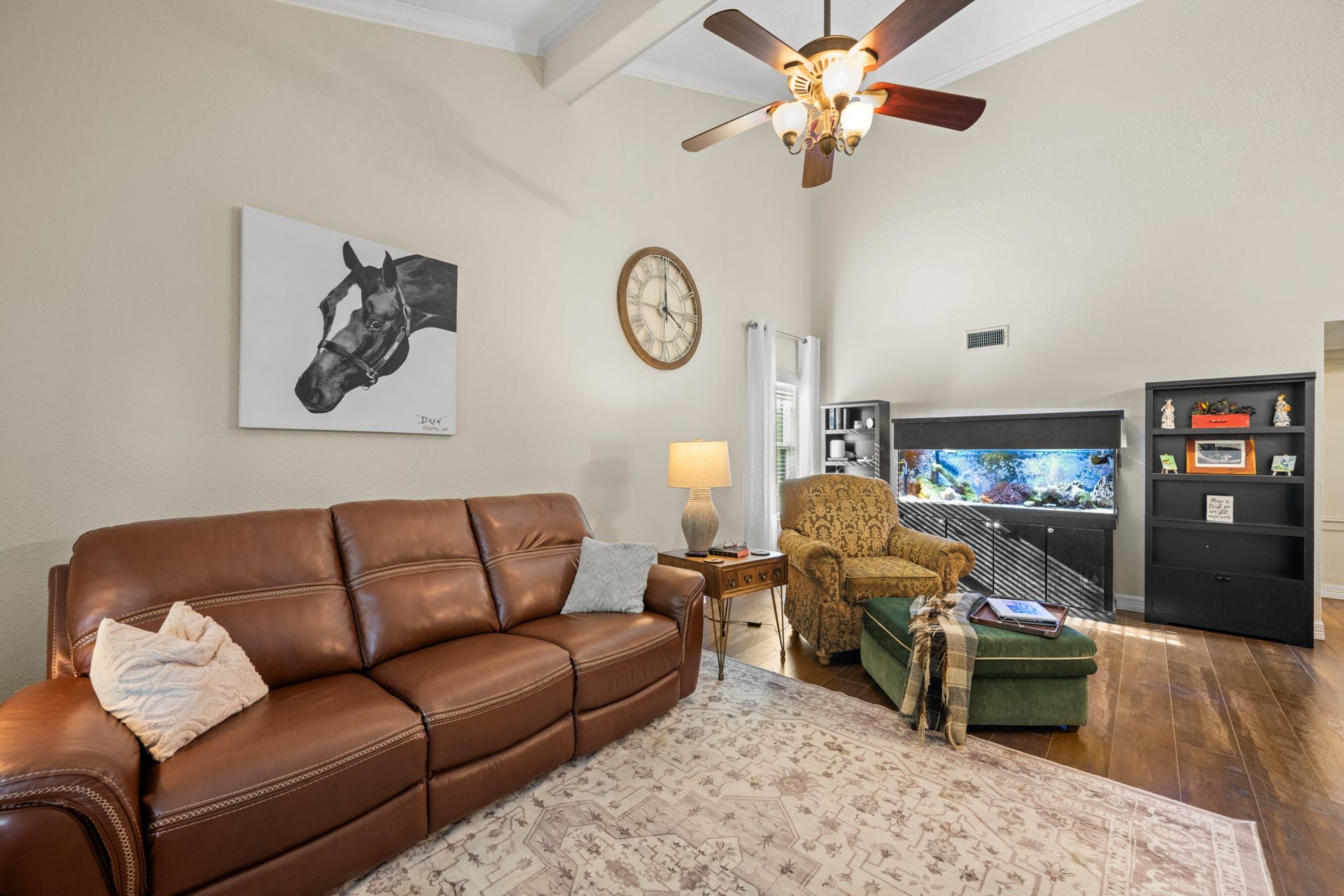 2215 Avenue Q, Santa Fe, TX 77510 Comfortable and spacious, this inviting family room features vaulted ceilings, a ceiling fan, warm wood-look flooring, and ample room for relaxing or entertaining.