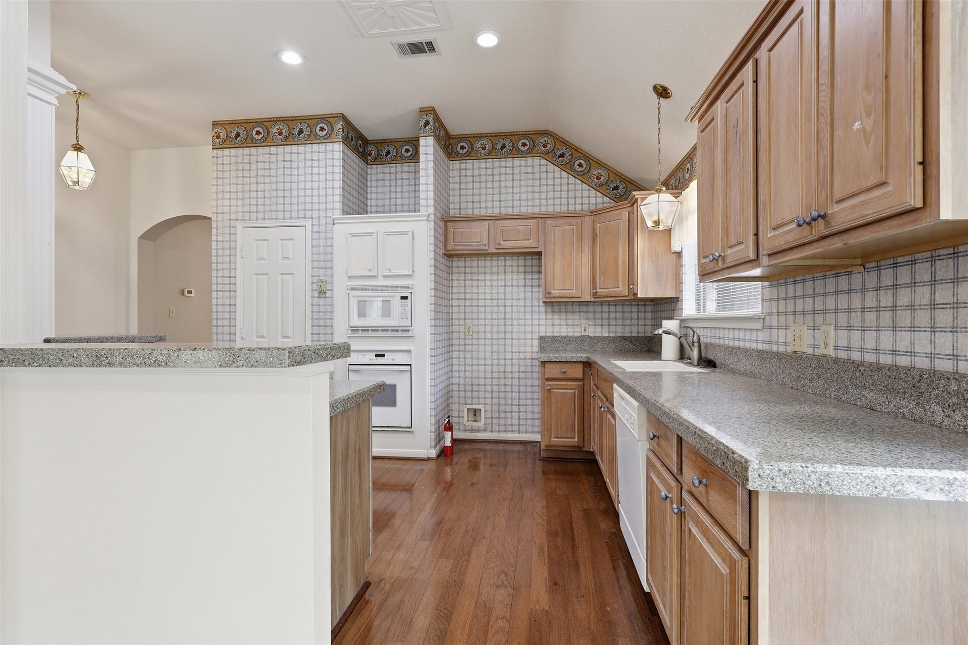10707 Crestfield Court, Houston, TX 77070 Light wood cabinetry, granite countertops, and a NEW DISHWASHER!