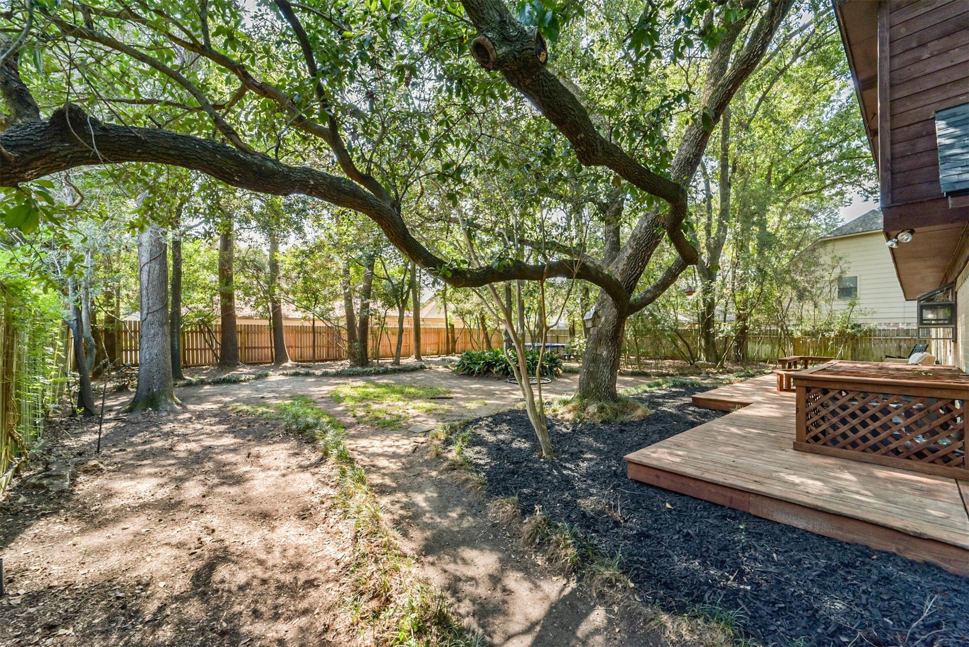 7618 Hurst Forest Drive, Humble, TX 77346 Backyard sneak peek! A sprawling shade tree creates a memorable backdrop for backyard living. Picture an afternoon on the deck, a relaxed weekend gathering, or simply enjoying the view beneath its sweeping branches.