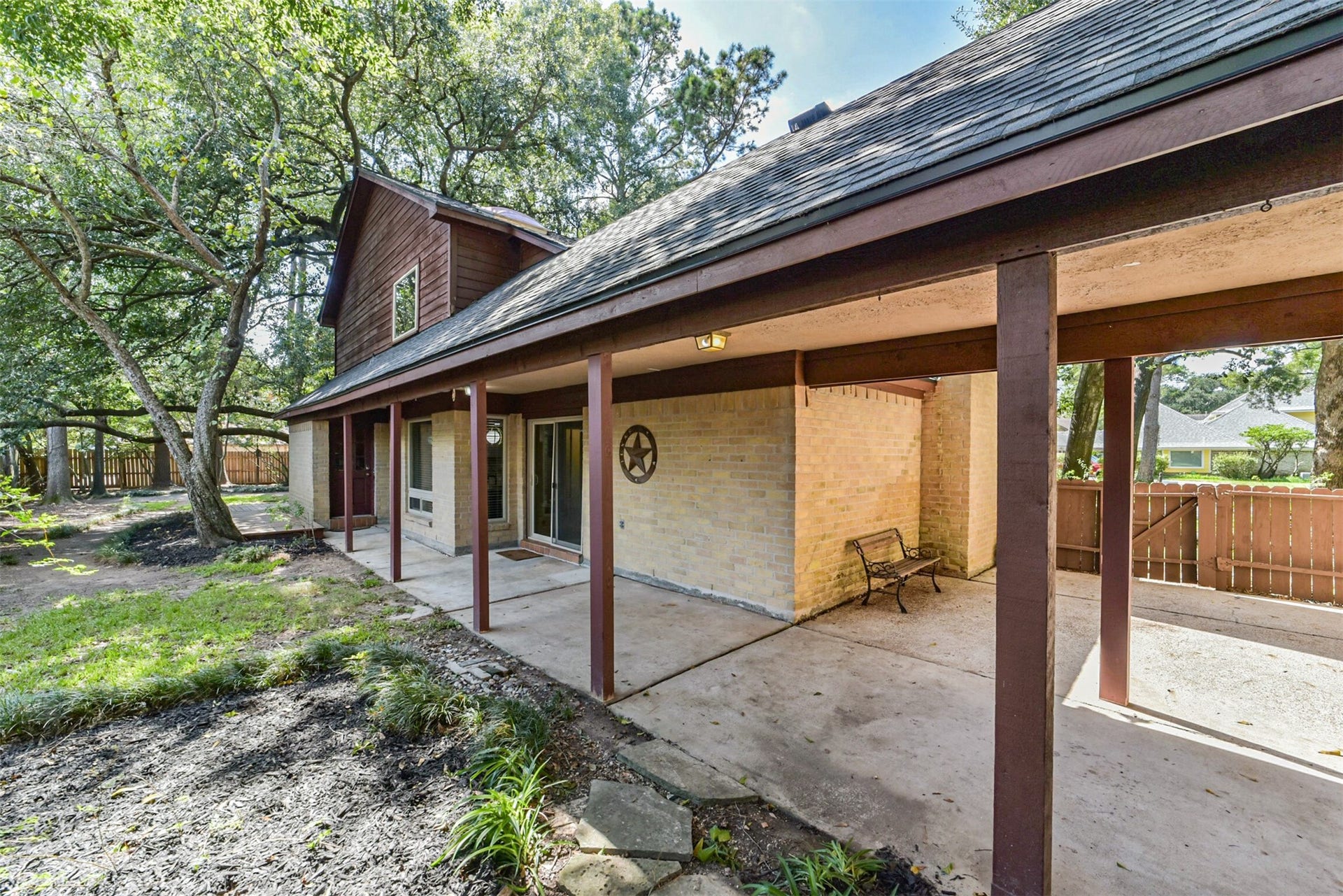 7618 Hurst Forest Drive, Humble, TX 77346 Stretching along the home, the covered patio provides room to create separate spaces for outdoor dining and relaxing. Enjoy fresh air beneath the shelter of the roof, with mature trees adding to the peaceful setting.