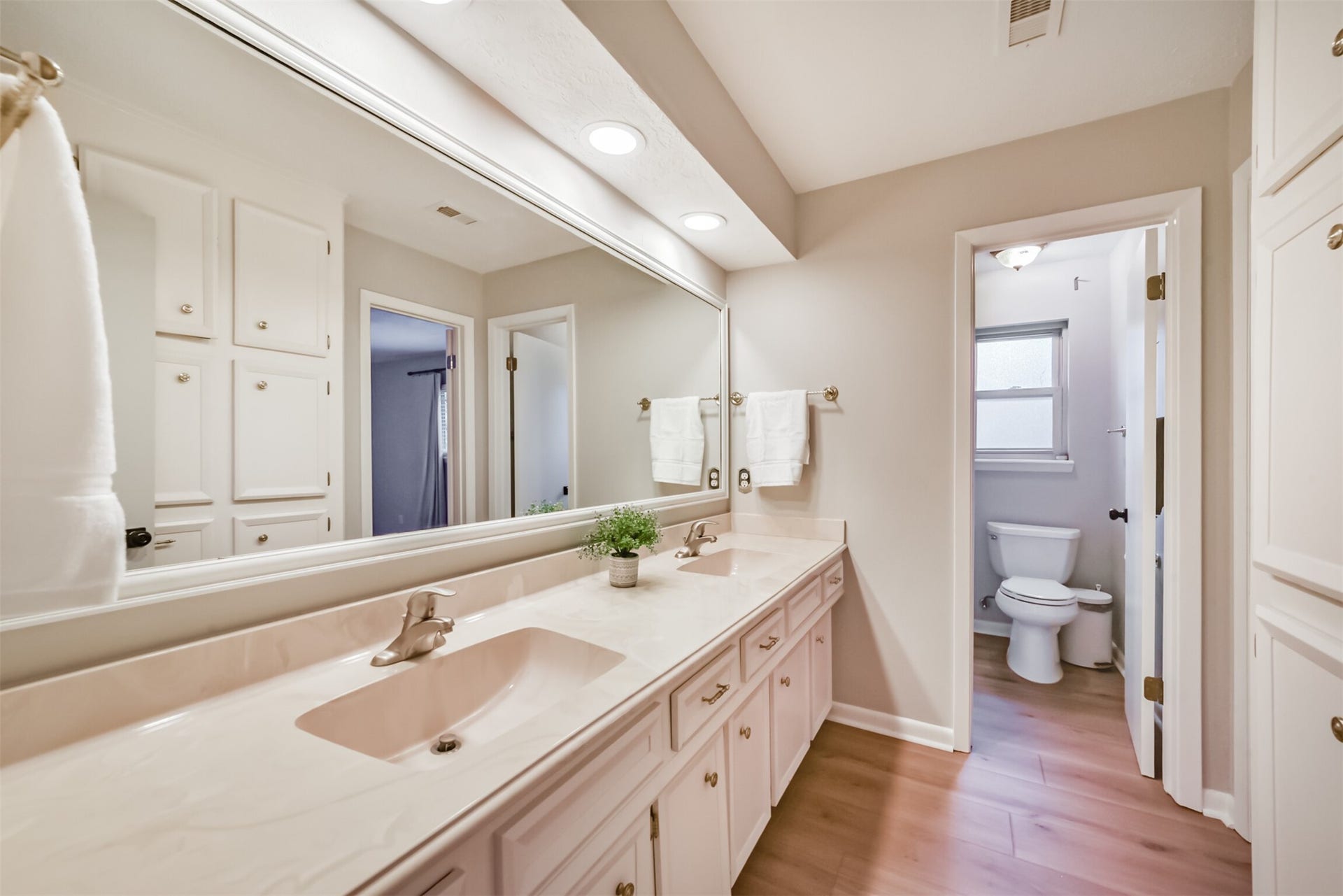7618 Hurst Forest Drive, Humble, TX 77346 A long vanity, expansive mirror, and abundant cabinetry provide plenty of space for daily routines and bathroom essentials. The separate toilet and bathing area allows added privacy while keeping the vanity accessible.
