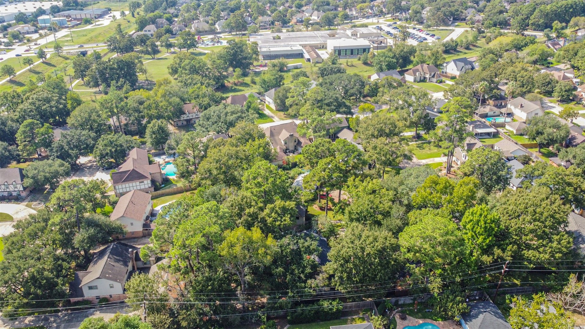 7618 Hurst Forest Drive, Humble, TX 77346 Discover a neighborhood defined by winding streets, established homes, and abundant tree cover. This wider view captures the inviting surroundings that make coming home feel a little more peaceful.