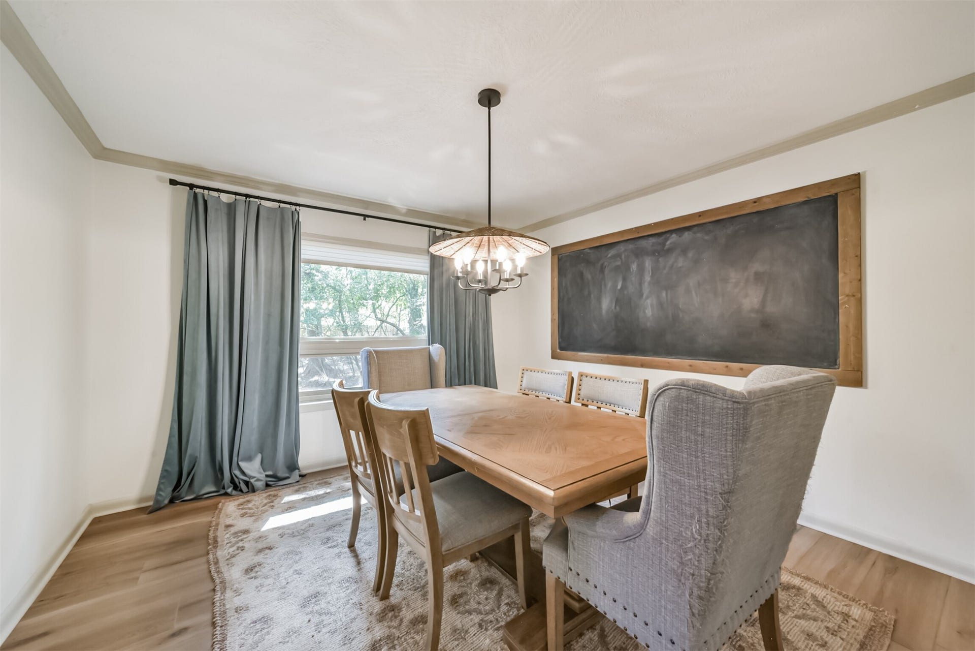 7618 Hurst Forest Drive, Humble, TX 77346 Gather around the table in a separate dining room that makes shared meals feel special. Natural light, crown molding, and a statement chandelier create a welcoming setting for holiday dinners or relaxed evenings with friends.