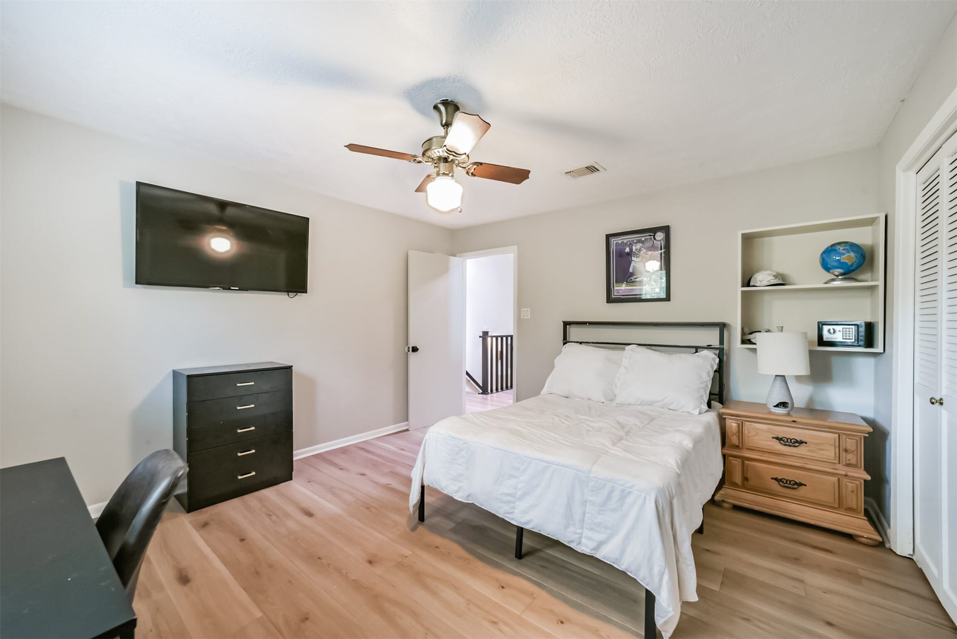 7618 Hurst Forest Drive, Humble, TX 77346 Built-in shelving adds useful display space and personality to this inviting bedroom. With room for a bed, dresser, and desk, the layout comfortably balances rest with work or study.