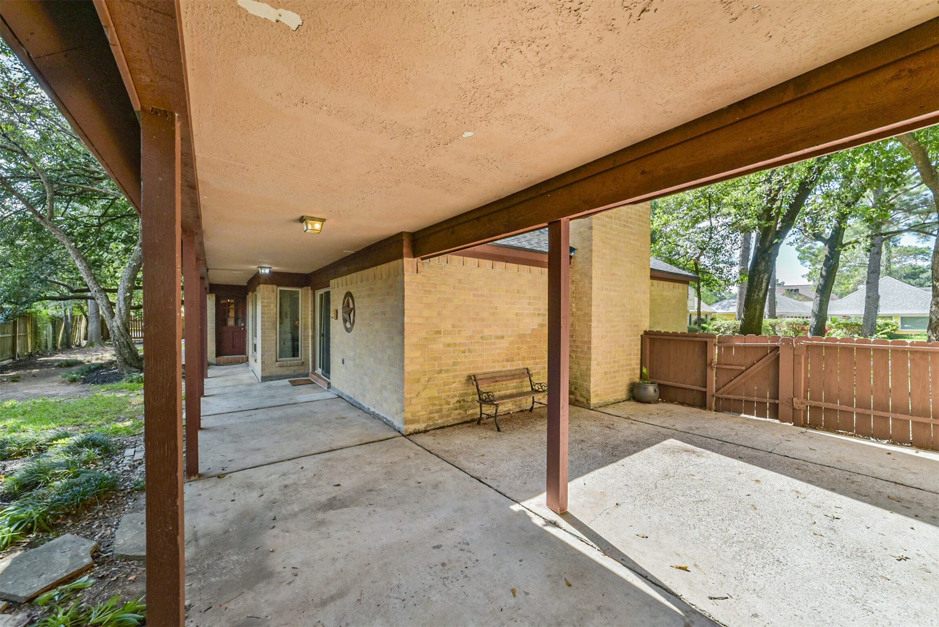 7618 Hurst Forest Drive, Humble, TX 77346 This generous covered outdoor area offers flexibility for seating, casual gatherings, or a quiet shaded retreat. Its connection to the surrounding yard makes it a natural extension of the homes living spaces.