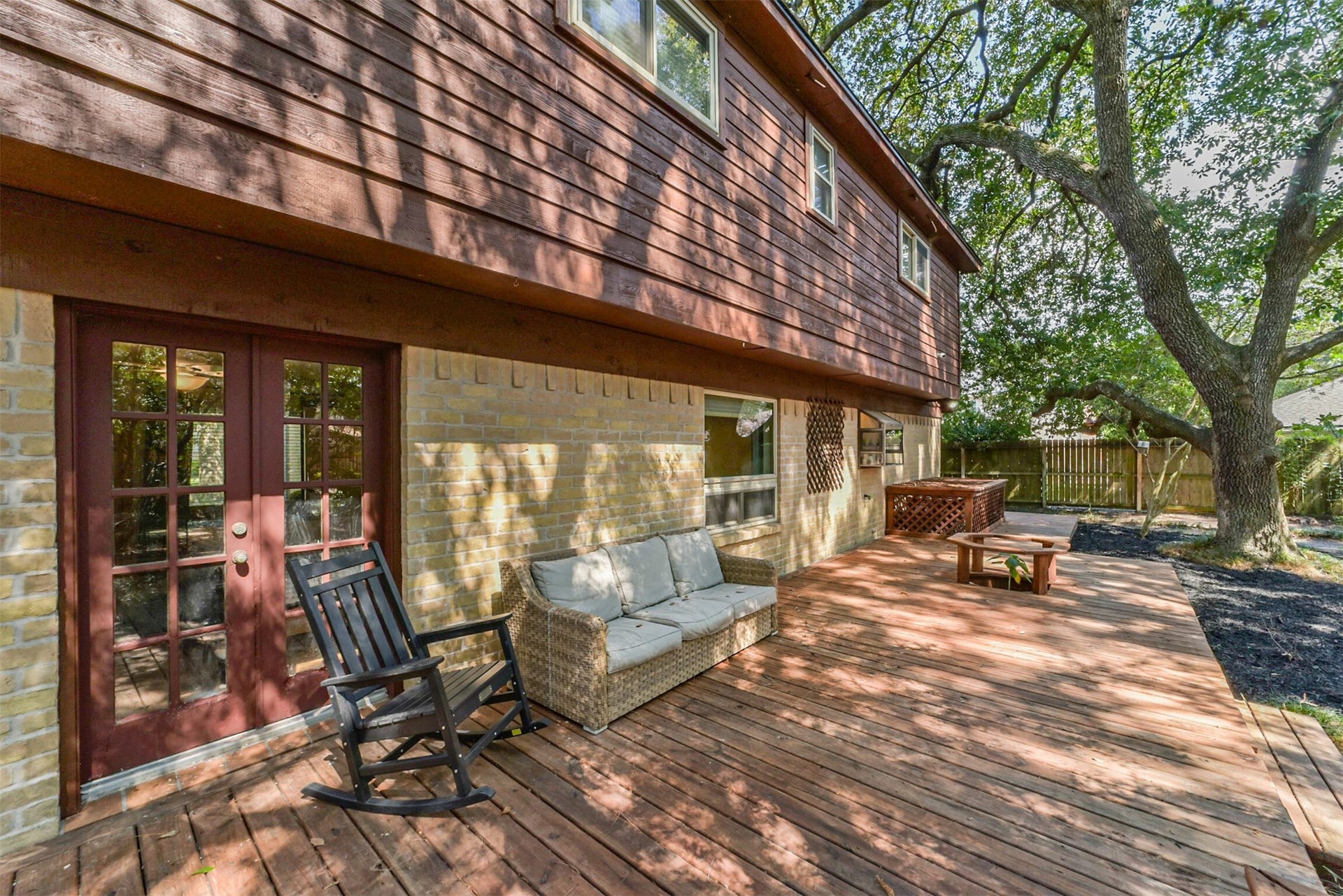 7618 Hurst Forest Drive, Humble, TX 77346 The spacious wood deck offers room for outdoor dining, comfortable seating, and easy entertaining. Direct access from the home makes it convenient to carry dinner outside or settle in for a quiet evening beneath the trees.