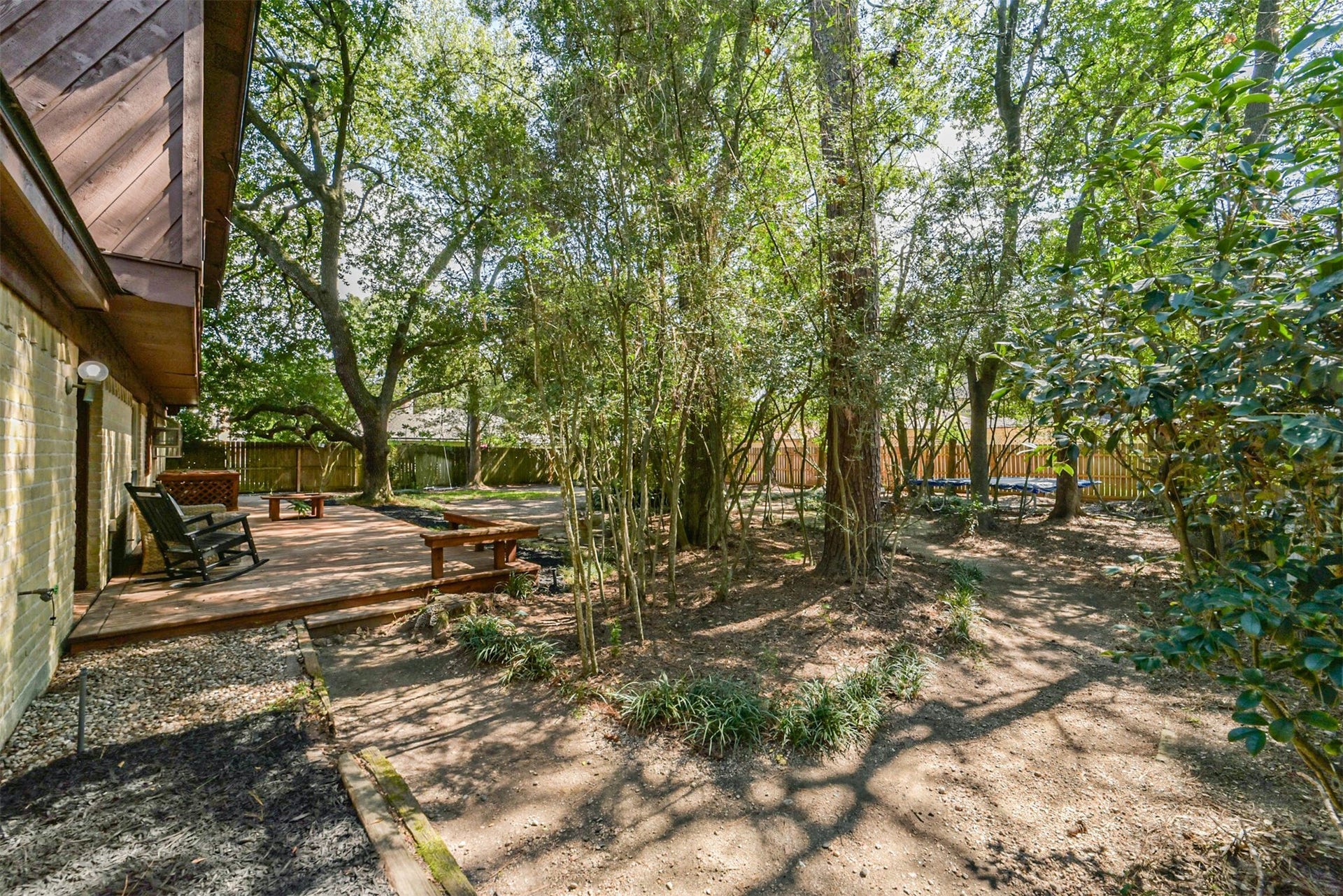 7618 Hurst Forest Drive, Humble, TX 77346 Step outside to a backyard where established trees and a wood deck invite a slower pace. Create your own garden corners, seating areas, or outdoor gathering spots within this naturally shaded setting.