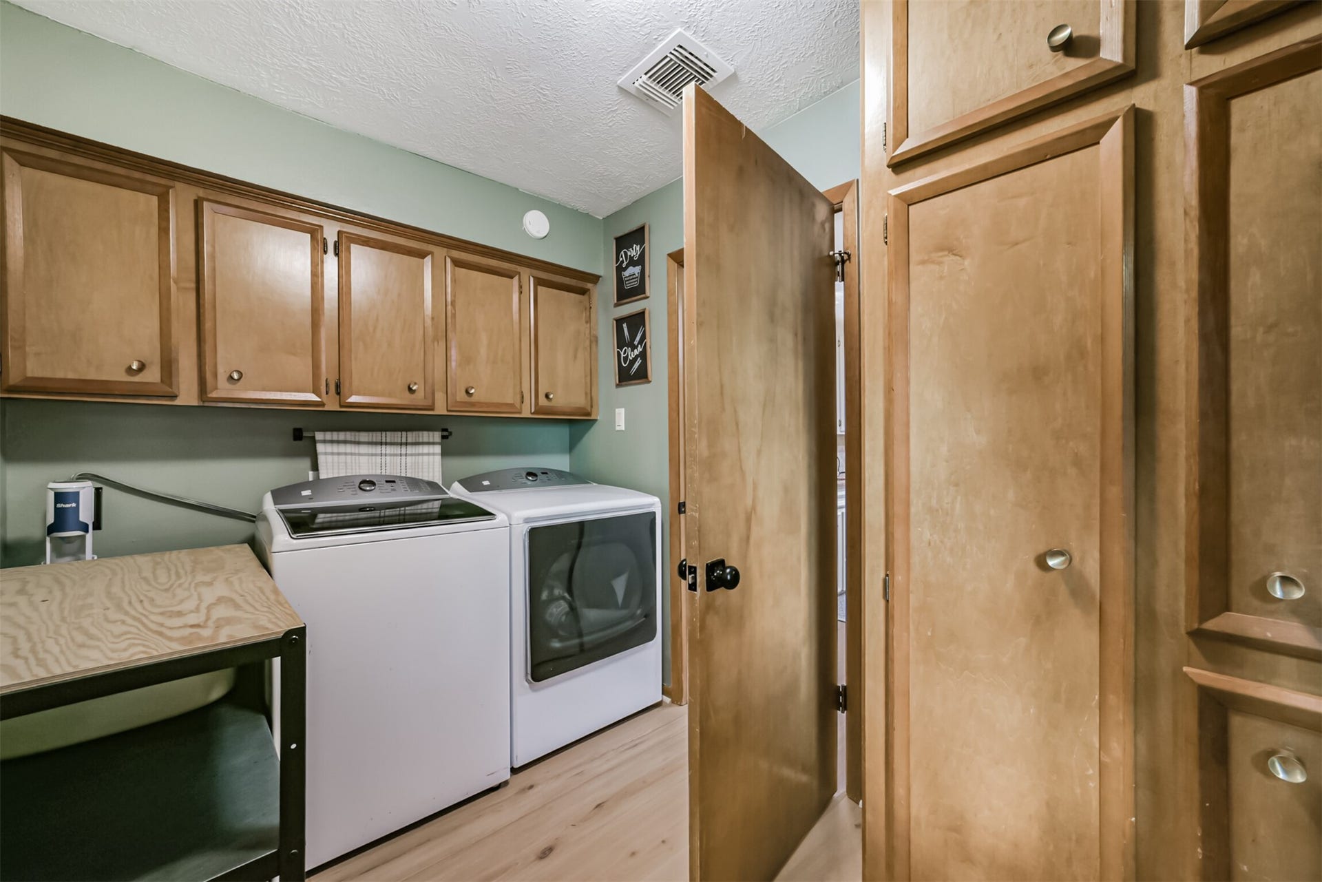 7618 Hurst Forest Drive, Humble, TX 77346 The dedicated laundry room brings organization to everyday chores with extensive cabinetry and a useful folding counter. Tall storage cabinets provide additional room to tuck away household supplies.