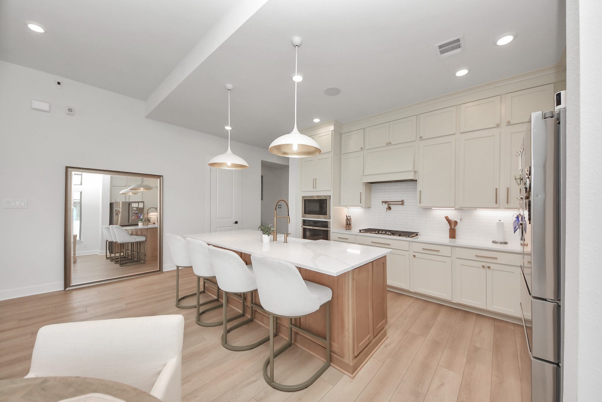 2995 Tantara Drive, Katy, TX 77493 Modern kitchen with a spacious island, sleek taupe cabinetry, and pendant lighting, perfect for entertaining.